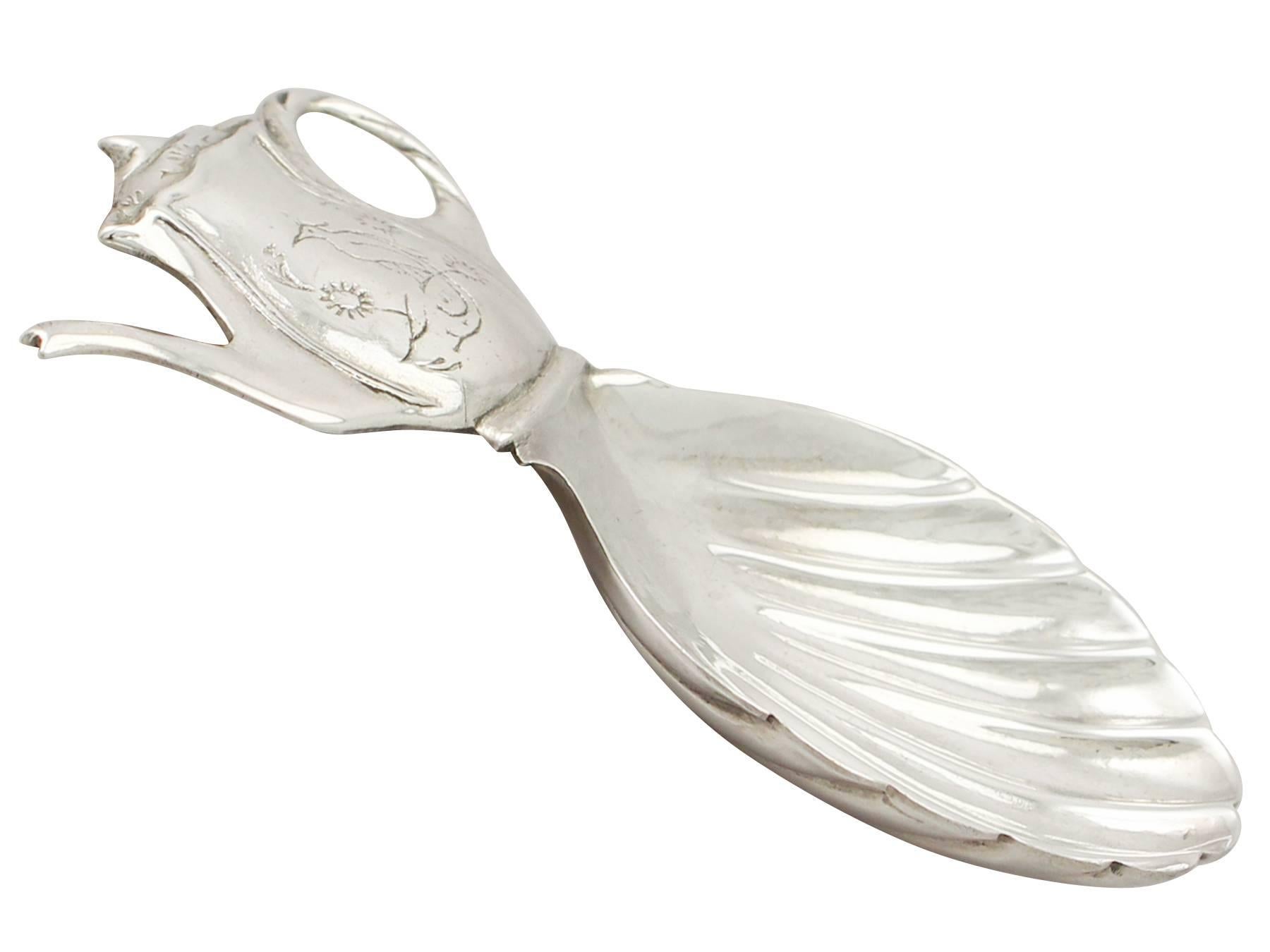 A fine and impressive, unusual vintage George VI English sterling silver caddy spoon; an addition to our teaware collection.

This fine vintage George VI sterling silver caddy spoon has an embossed shell shaped bowl.

The handle is realistically