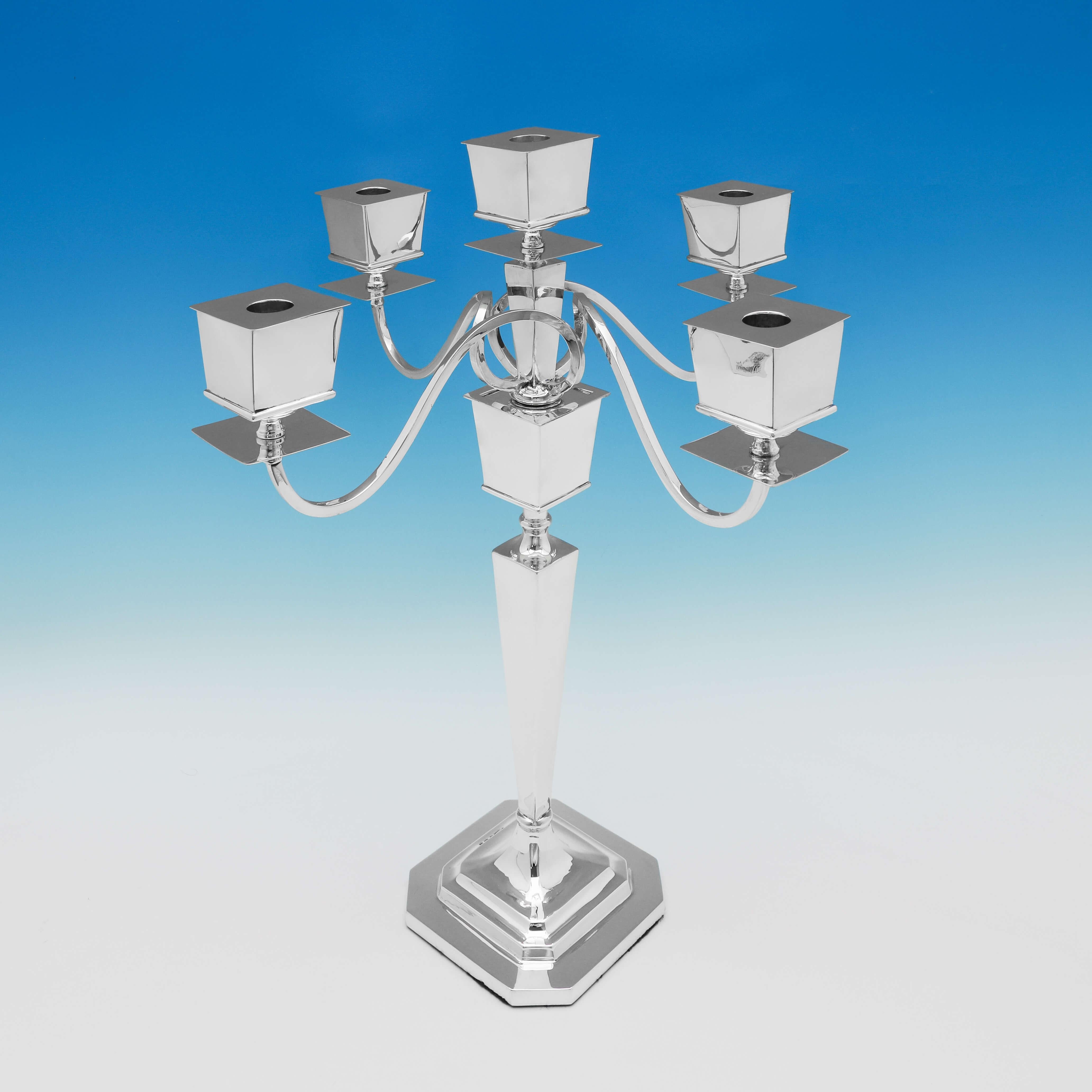 Hallmarked in Birmingham in 1926 by Britton, Gould & Co., this very stylish, sterling silver candelabrum, is in the Art Deco taste, with space for 5 candles. The candelabrum measures 19.5
