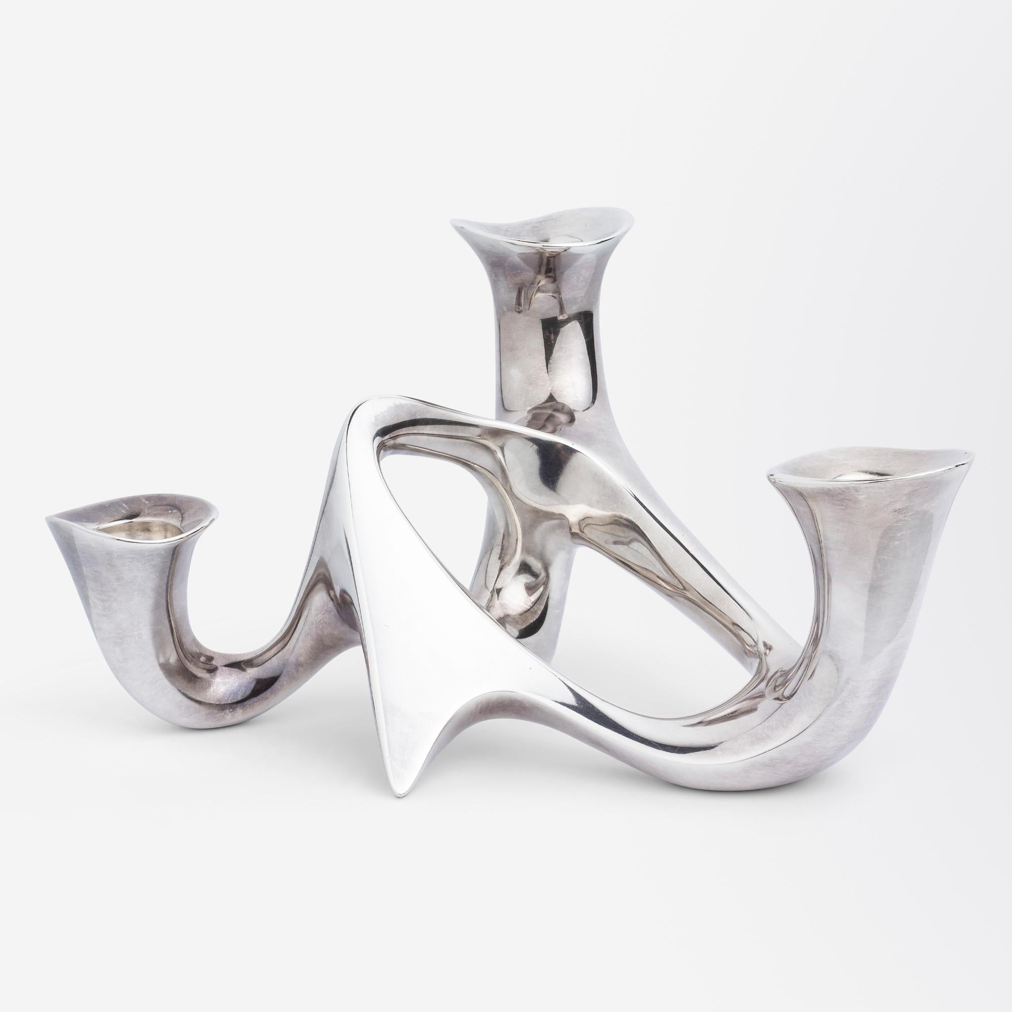 A modernist sterling silver candelabra with an organic, sculptural form designed by Henning Koppel (1918-1981) for Georg Jensen in 1946 entitled #956. This was Koppel's first hollowware design for Georg Jensen and was quite a radical departure for