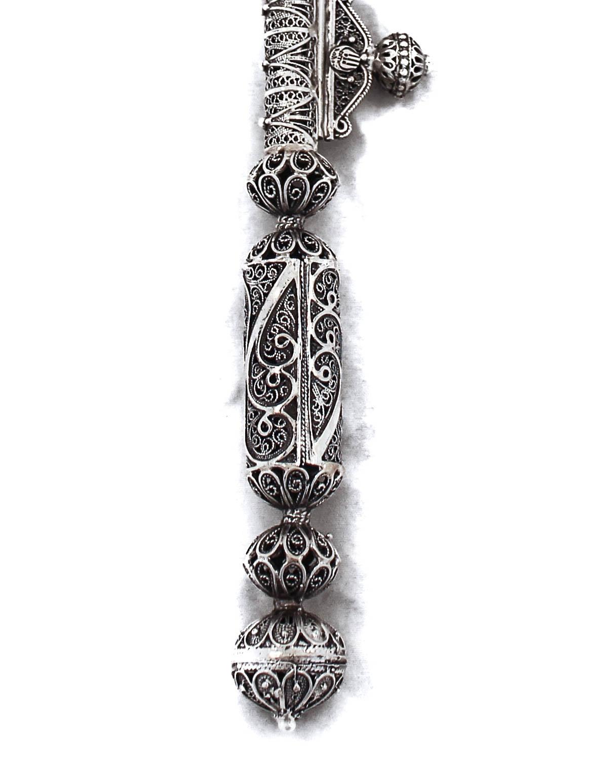 Being offered is a sterling silver filigree candlelighter. Handmade in a filigree design, it invokes the craftsmanship of Israeli artisans and the world renowned Betzalel Academy of Arts and Design in Jerusalem. The artists are known to blend