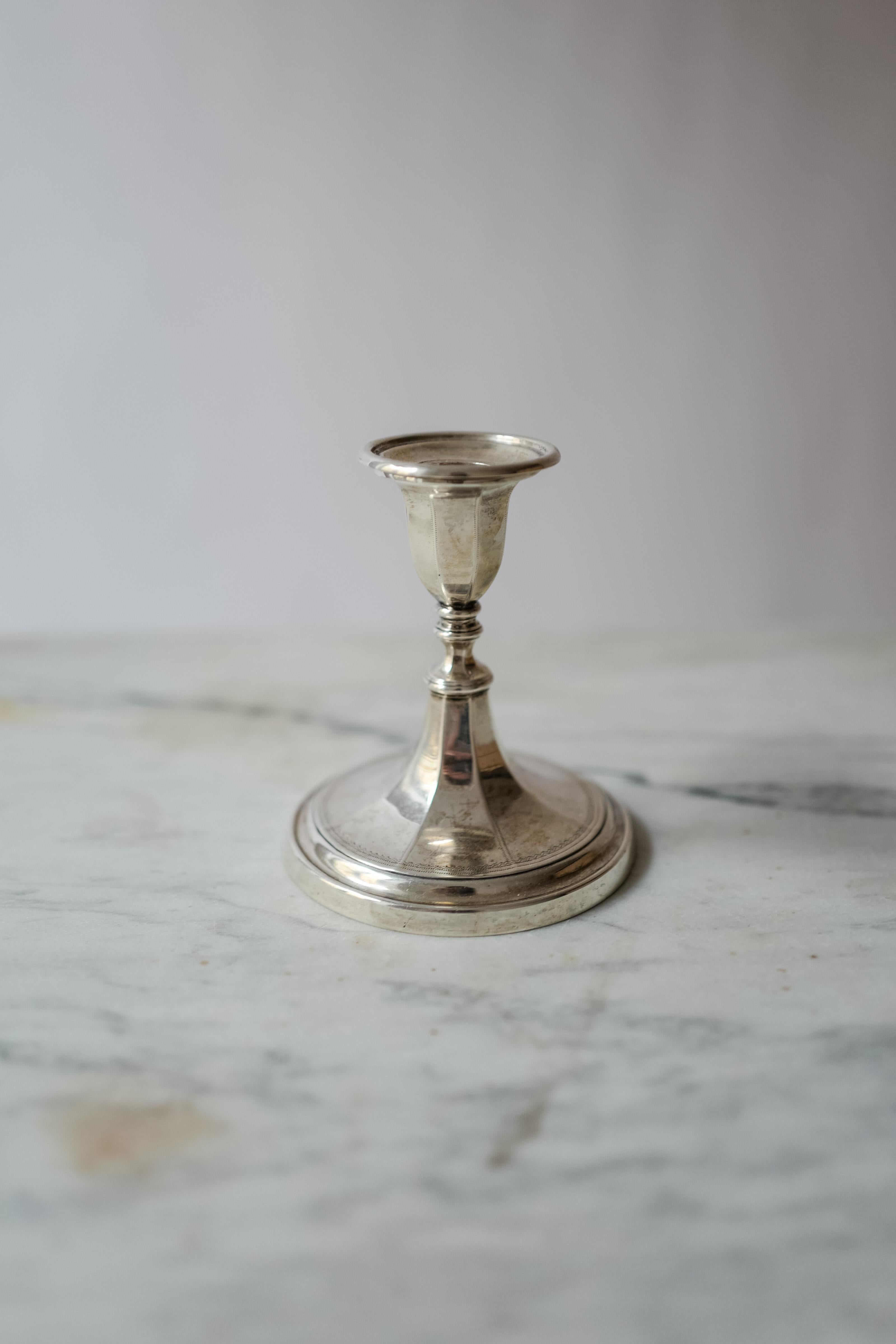 A single sterling silver candlestick marked Harrods London inside (see photo). Silver markings include W.F. A.F for Fordham & Faulkner - William Charles Fordham & Albert Faulkner entered 1896, a Sheffield crown, a lion for the English Assay Office,