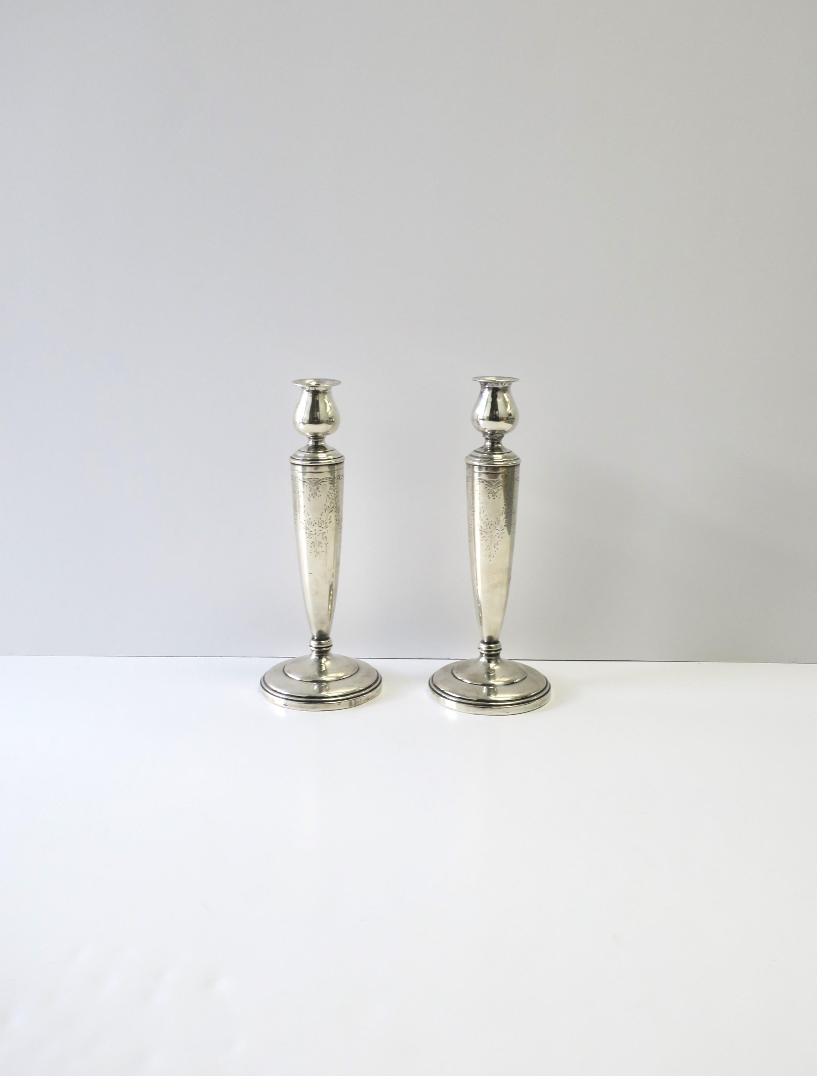 A pair of European sterling silver candlestick holders with decorative etched design, circa early 20th century, Europe. Marked 'Sterling' on bottom as shown. Measure: 9.63