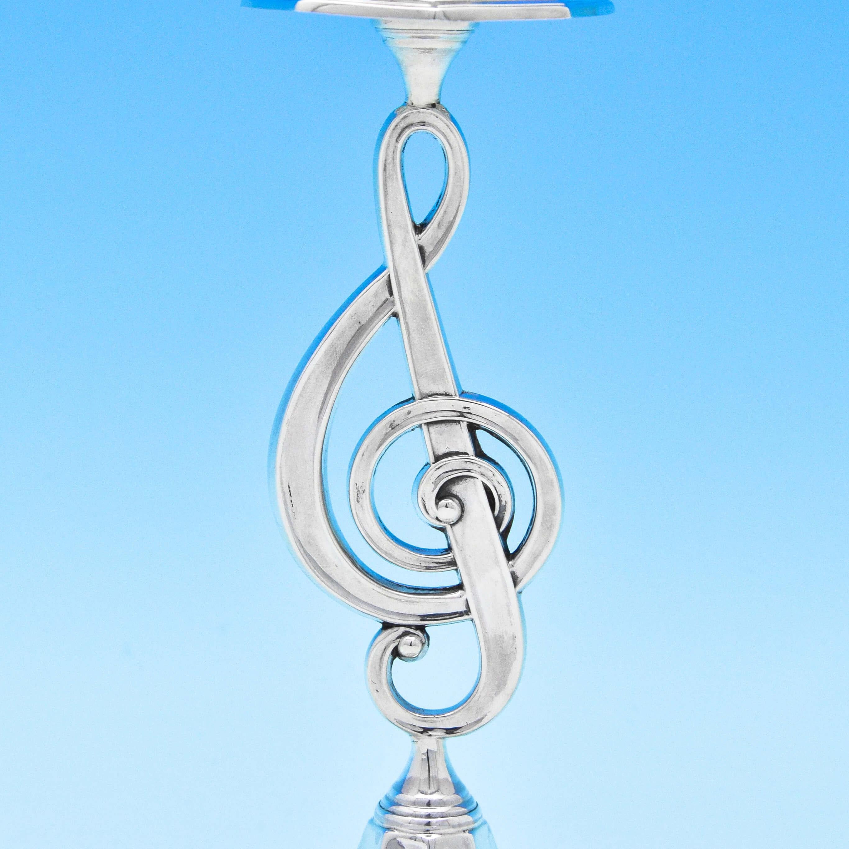 Hallmarked in London in 1898 by John Round & Son Ltd., this delightful and unusual, Pair of antique, Victorian, sterling silver candlesticks have a musical theme, featuring columns in the from of treble clefs. Octagonal in shape with neoclassical