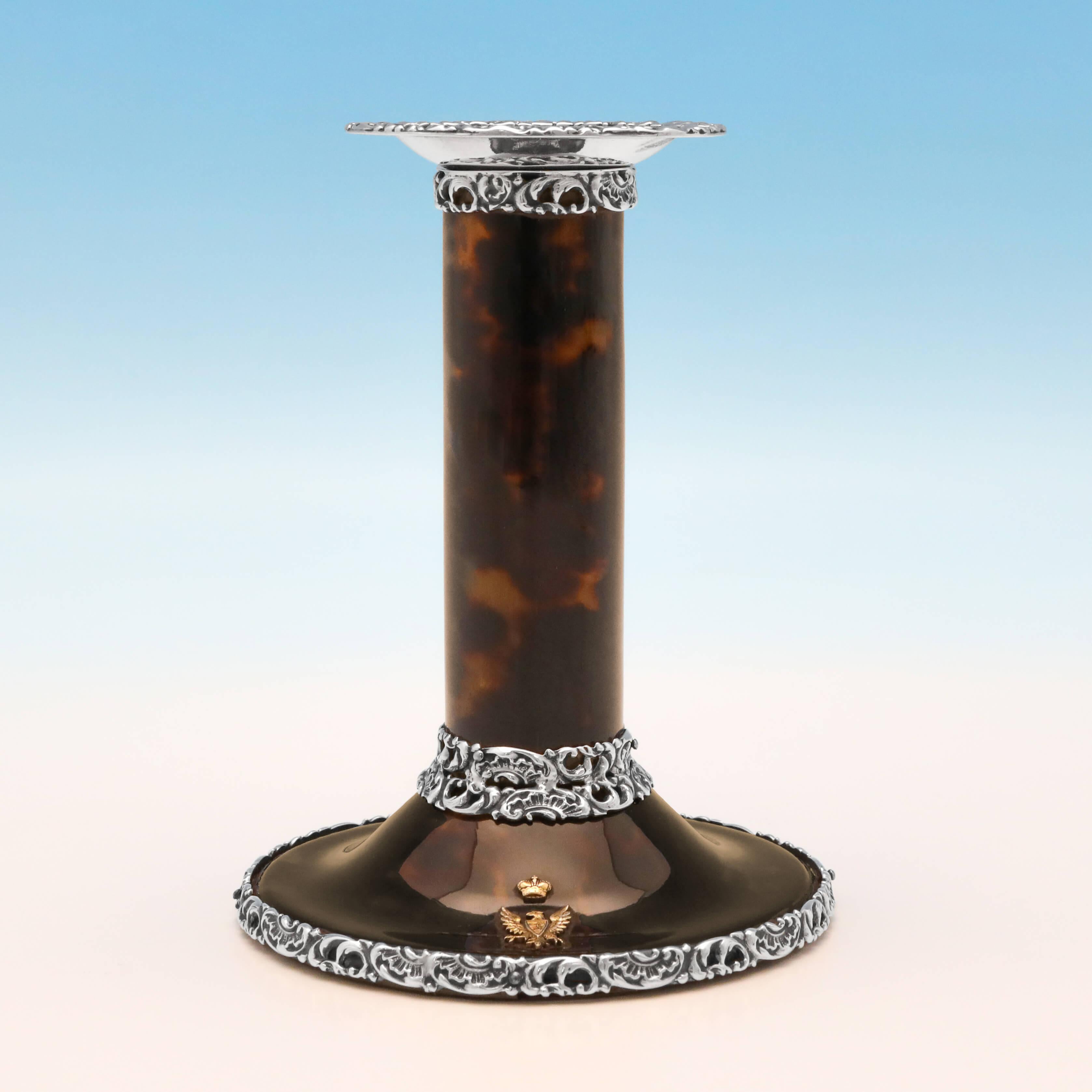 Hallmarked in London in 1898 by John Batson & Sons, this wonderful pair of Victorian, antique sterling silver candlesticks, are made of tortoiseshell, with elaborate silver mounts and an applied gold crest to each. Each candlestick measures