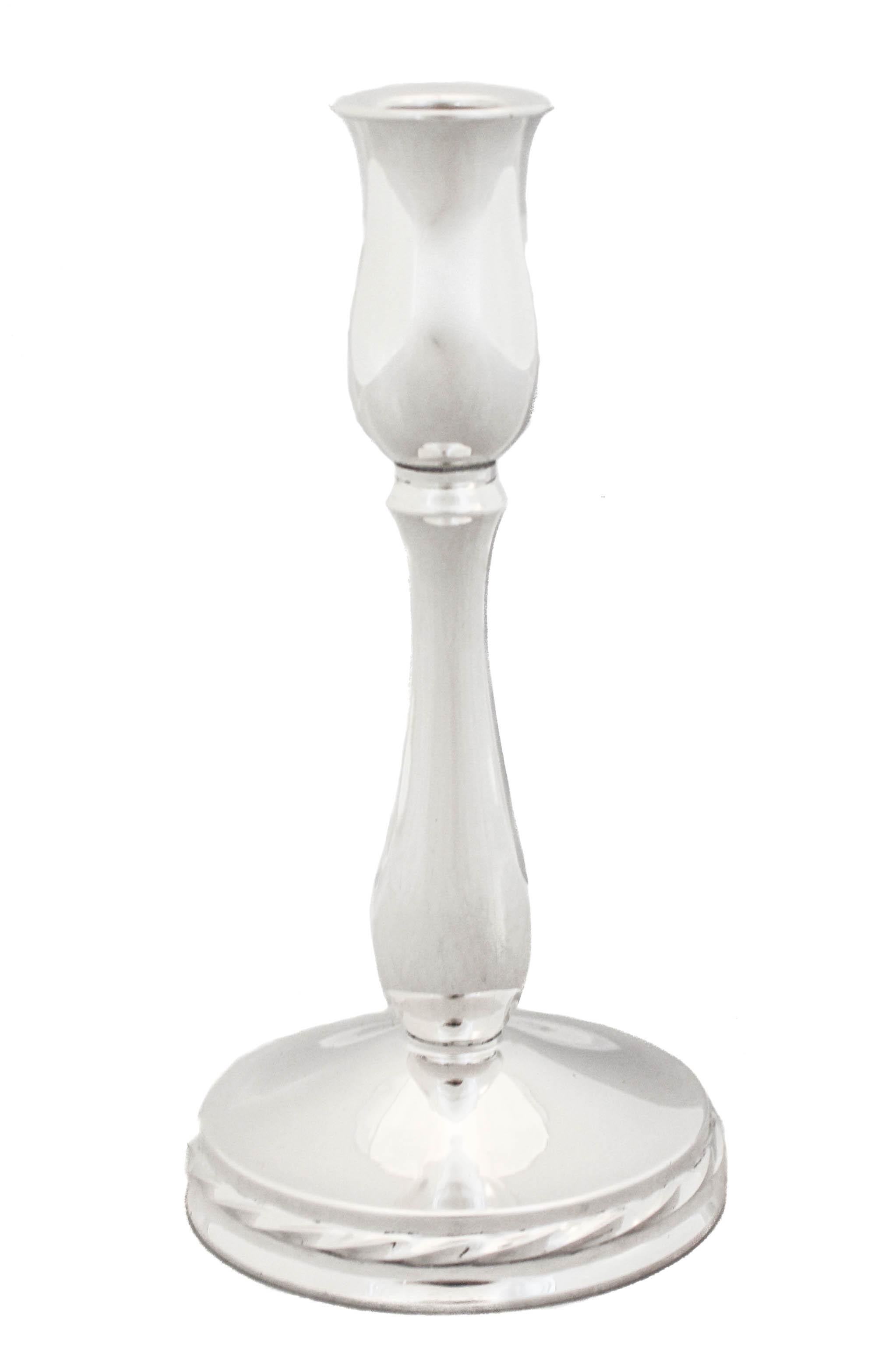 These sterling silver candlesticks are sleek and contemporary. Made by Towle Silversmiths they have a tulip shape and a gadroon design around the base. Perfect for any decor and timeless.