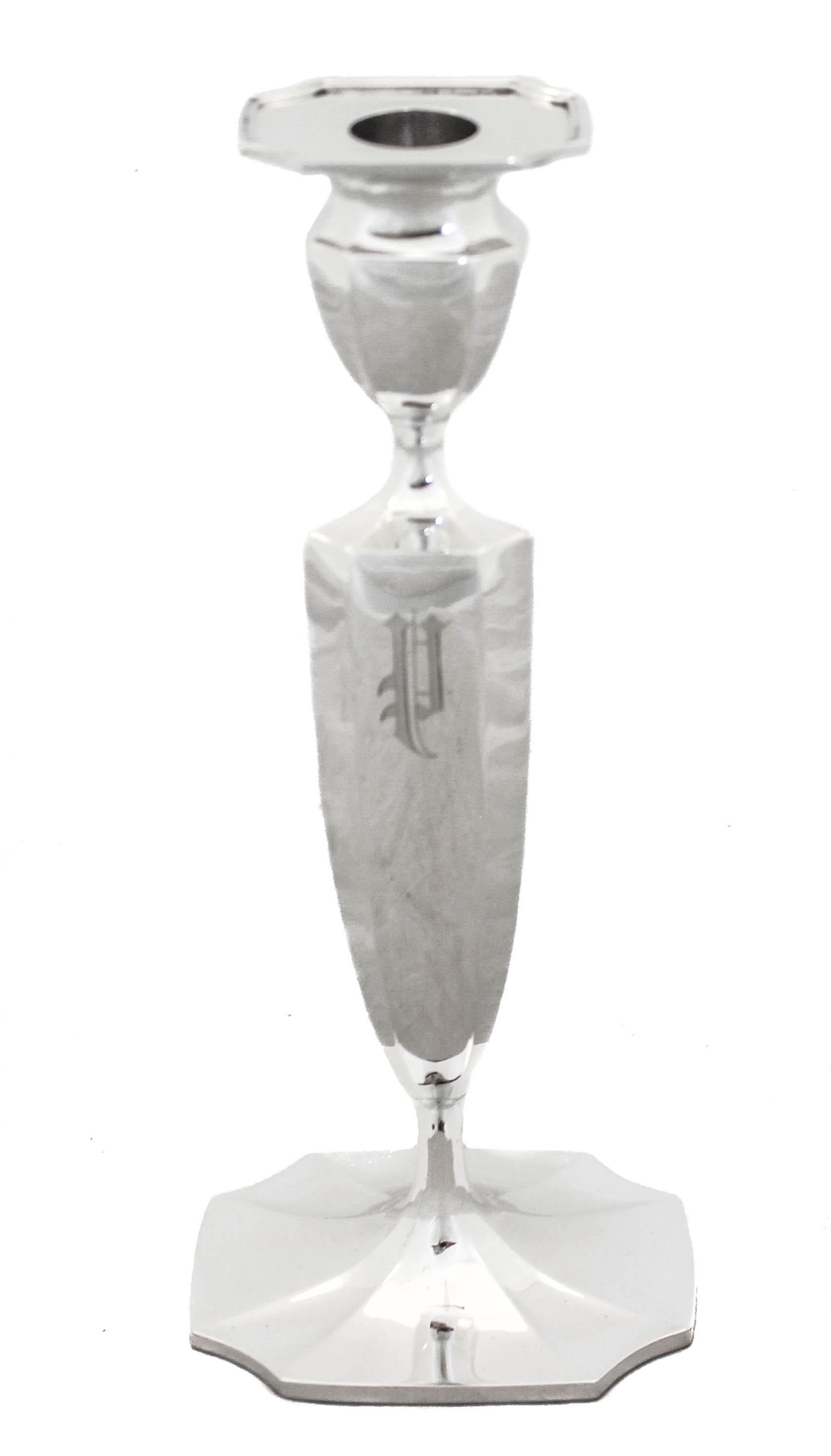 Being offered is a pair of sterling silver candlesticks by Reed and Barton. These candlesticks are very handsome and have a paneled body with a matching base and bobeche. A tapered shape and straight lines make for an elegant and sophisticated look.
