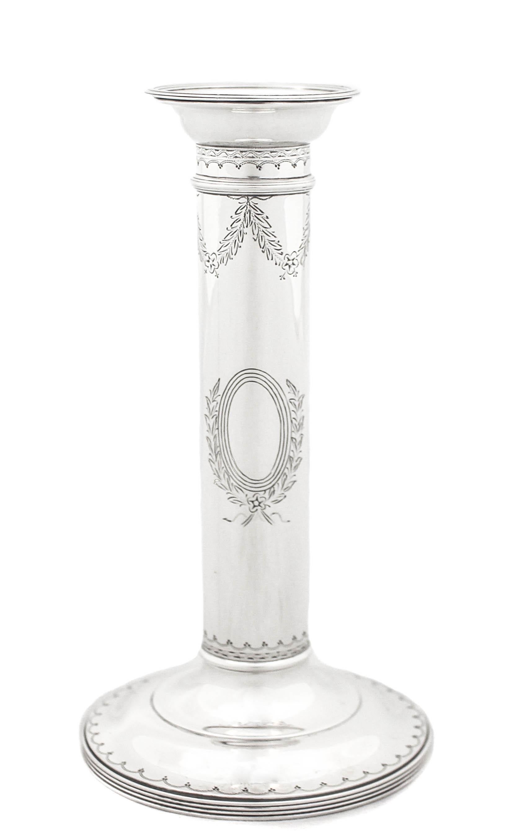 Being offered is a pair of sterling silver candlesticks by William Durgin.  They are column-shaped in the Tuscan style. A Tuscan column looks basically like a Doric column, except it is not fluted.  It has a simple shaft that rests on a simple,