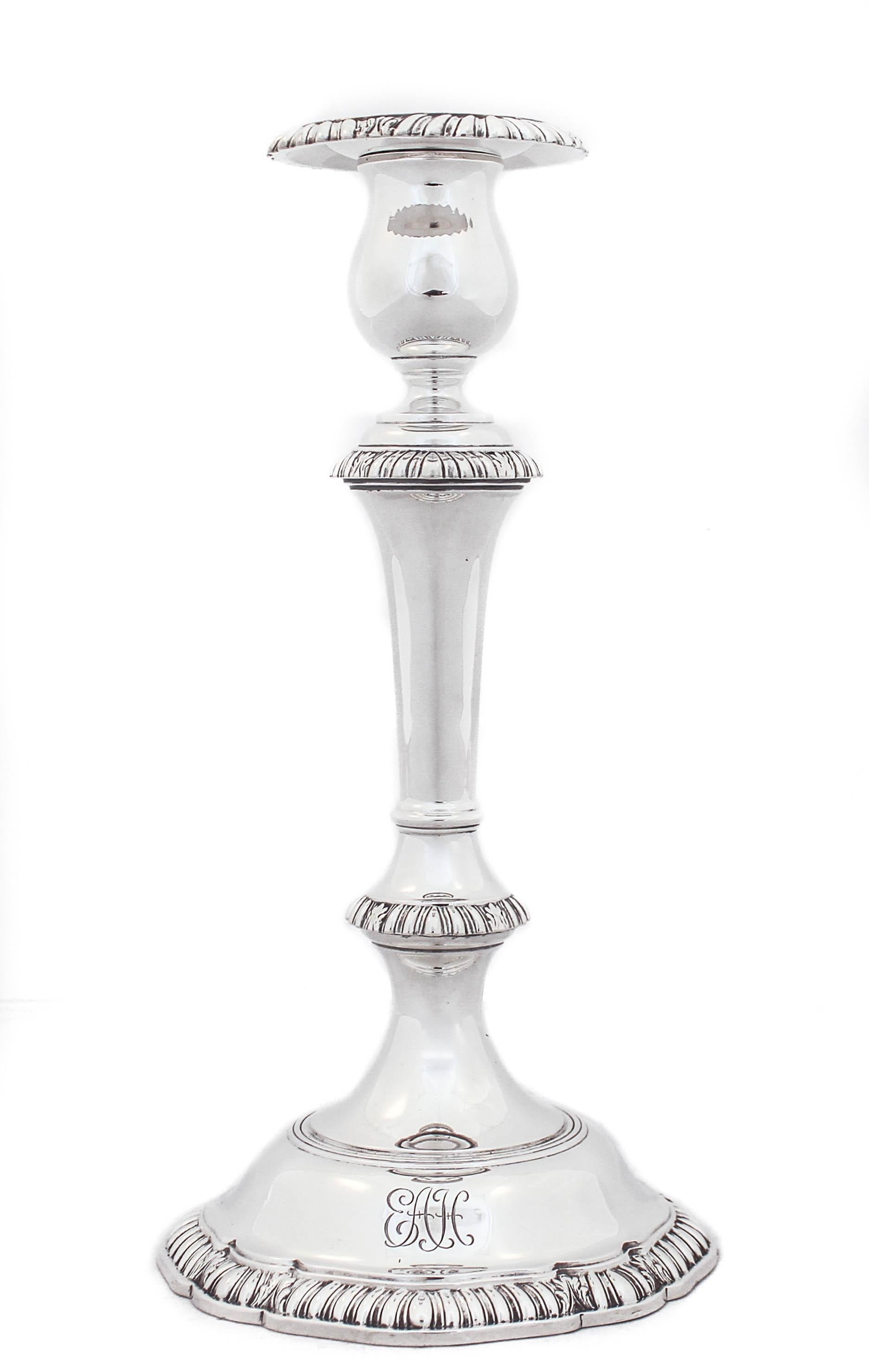 Being offered is a pair of sterling silver candlesticks by Graff, Washbourne & Dunn.  The have a gadroon design around the base, waist, neck and bobeche.  Their shape is classic in that it’s tapered and then opens out on the bottom.  The bobeche are