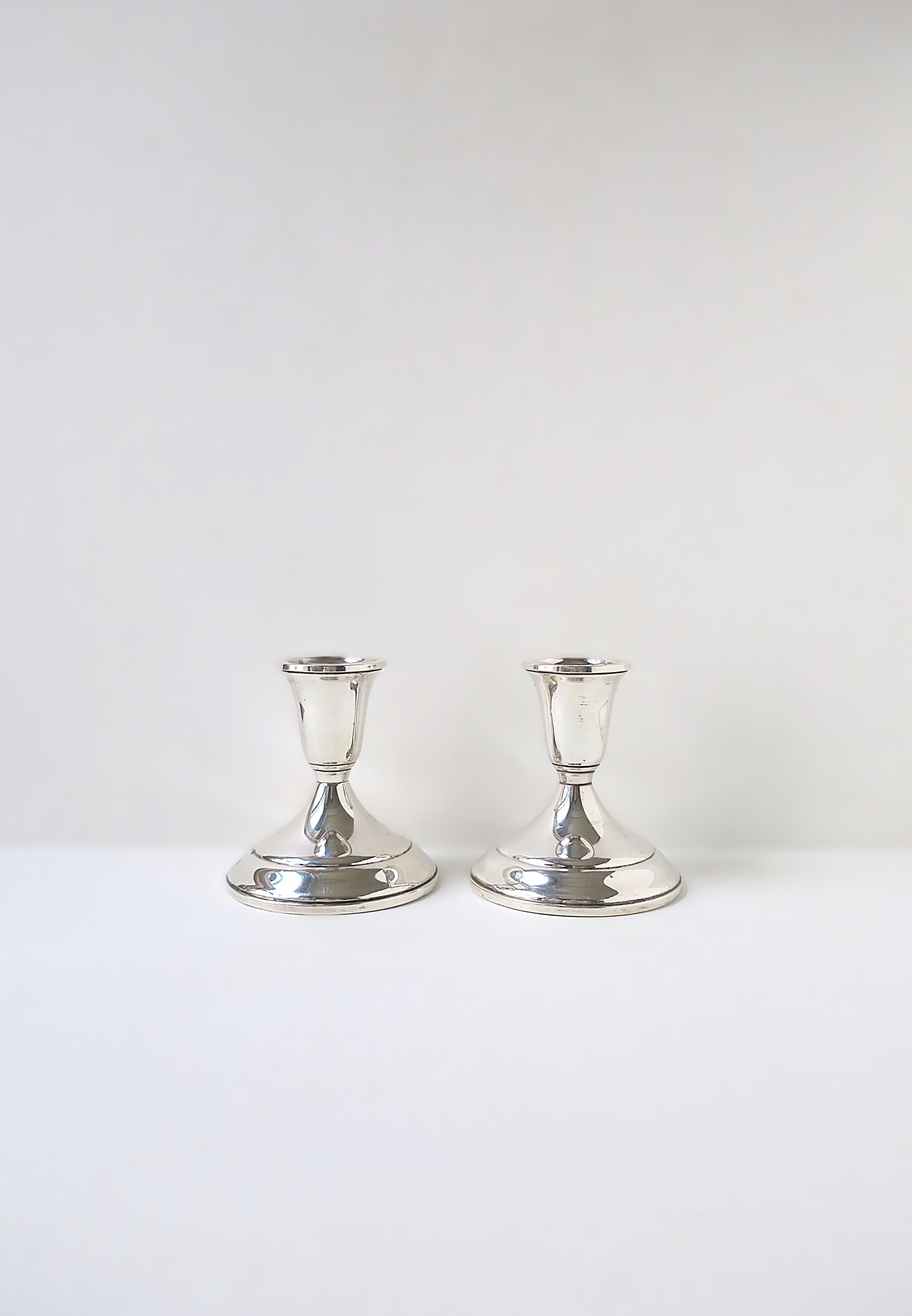 A beautiful versatile pair of sterling silver candlestick holders by Towle Silversmiths, circa mid to late-20th century, America. An elegant set for any dining table, mantle, sideboard, etc. Makers' mark: 'Towel', marked 'Sterling', '925', all on