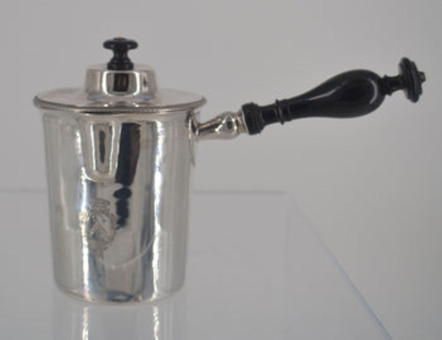 Sterling silver carafe with crest, used for hot milk or cream.