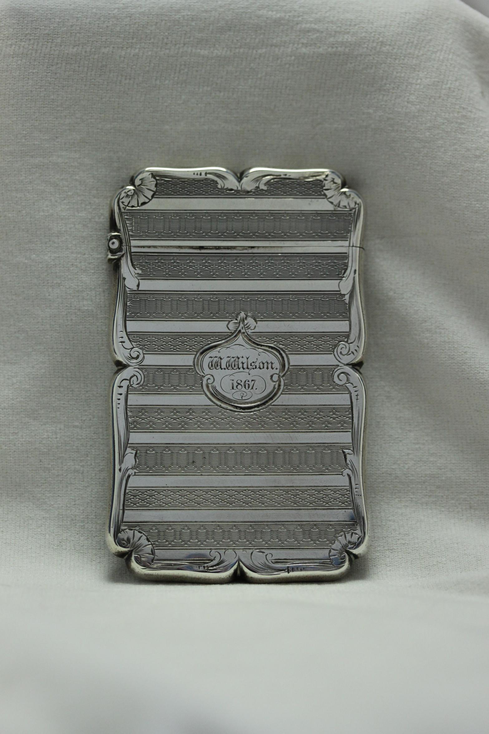 This very attractive sterling silver card case with a hinged top, was made by Edward Smith of Birmingham in 1853. Smith was a good maker, noted for making card cases decorated with engine turning and engraving. Interestingly, although it was made in