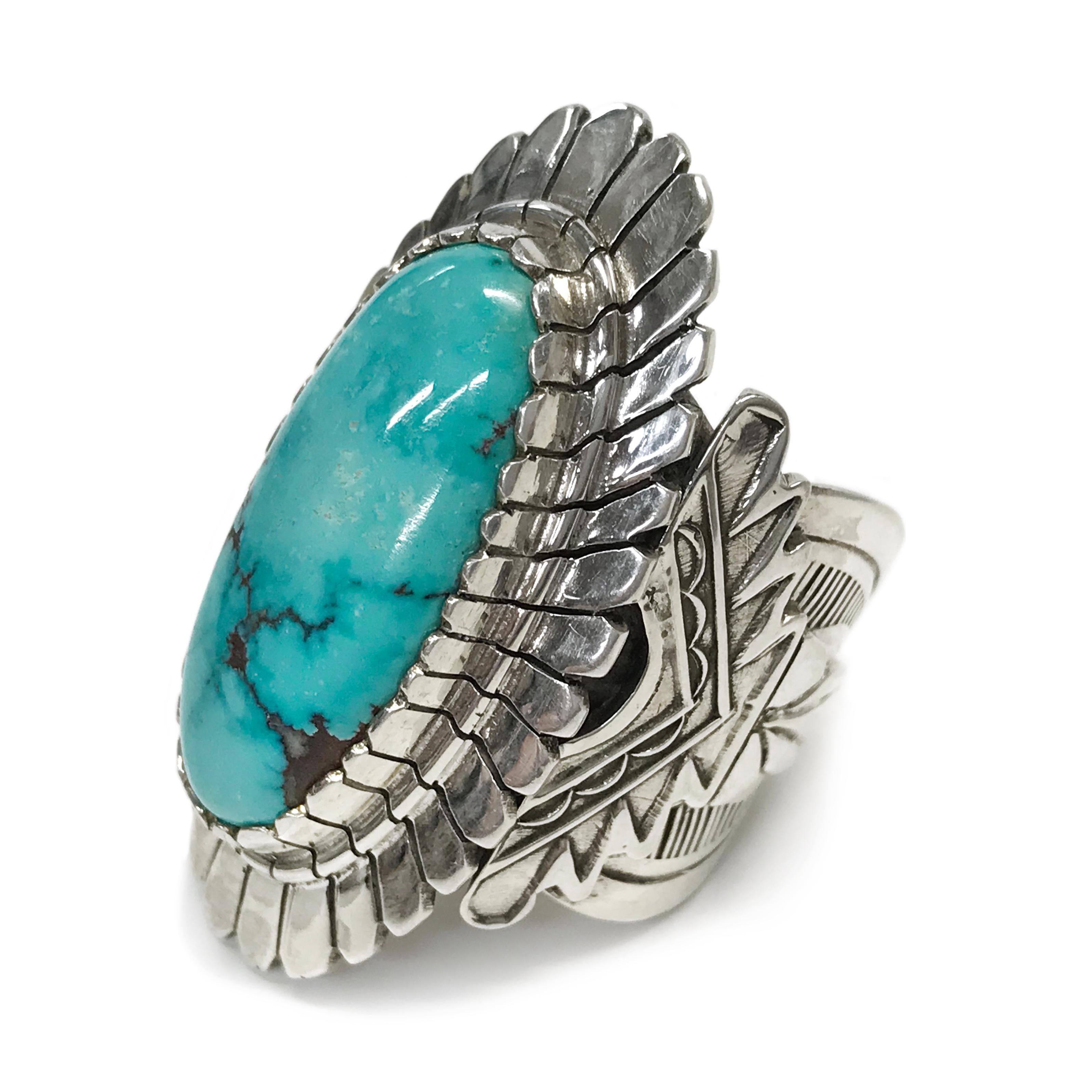 Handcrafted from Sterling Silver by jewelry maker, Ray Winner. This stunning ring features a large oval Carico Lake Turquoise cabochon set in a gorgeous wide Native American-inspired design band and bezel. The ring measures 23mm high x 24mm wide x