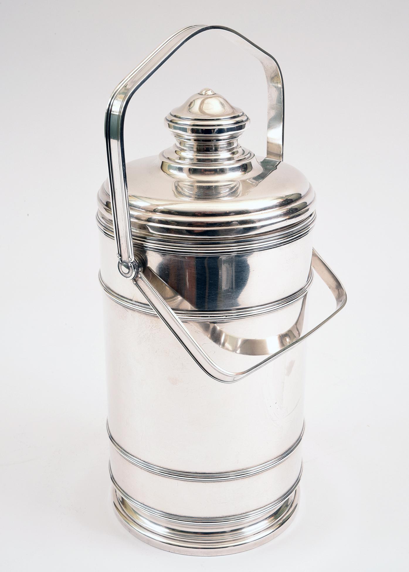 Early 20th century sterling silver Cartier covered ice bucket with two handles .The ice bucket front engraved MELODIE with interior Pyrex liner. The sterling silver ice bucket is in excellent vintage condition, minor wear consistent with age / use