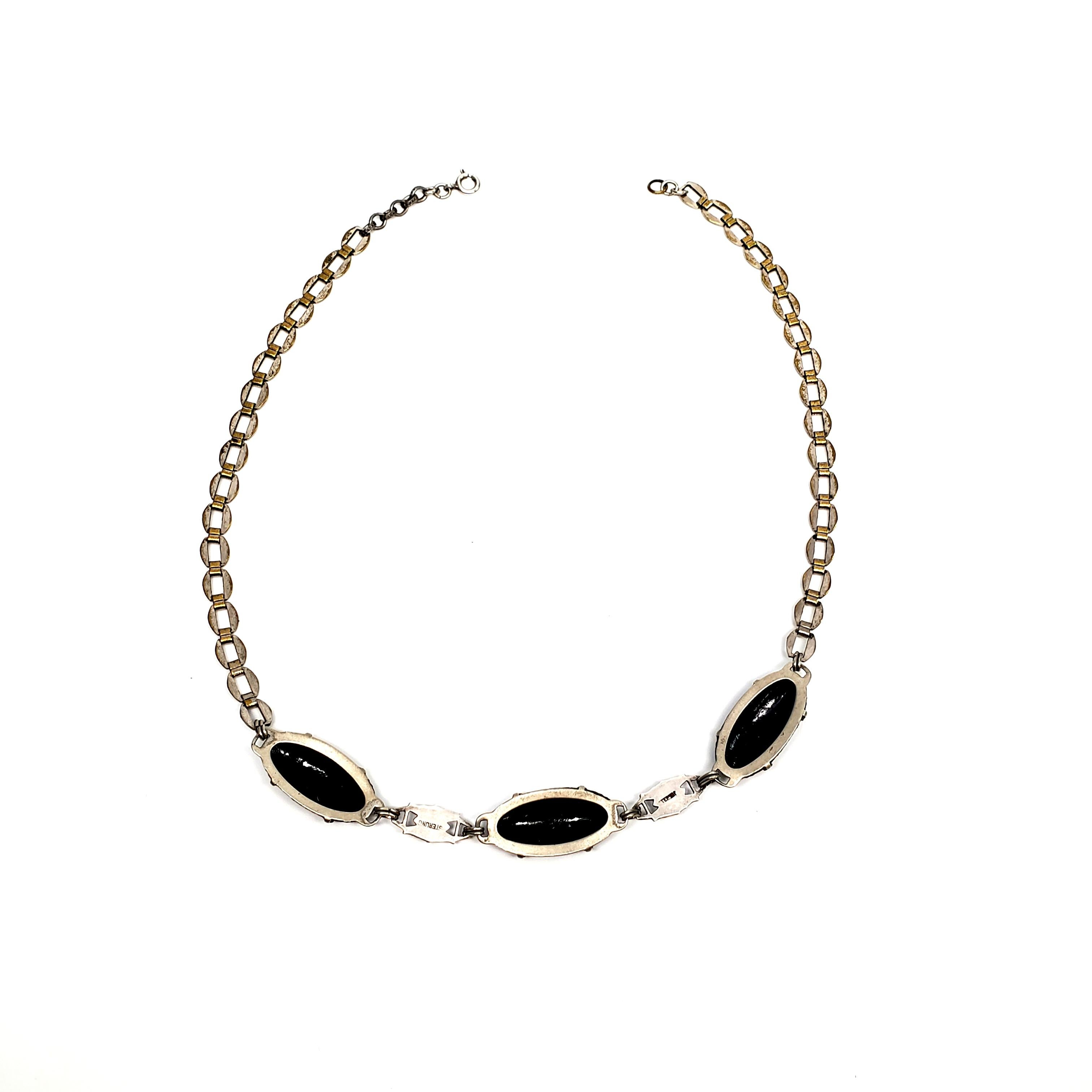 Antique Victorian sterling silver and gold accent carved french jet necklace.

The flat oval chain links are etched sterling silver with with gold accents. Three oval carved black jet beads with flat marcasite accented links.

Measures approx 16