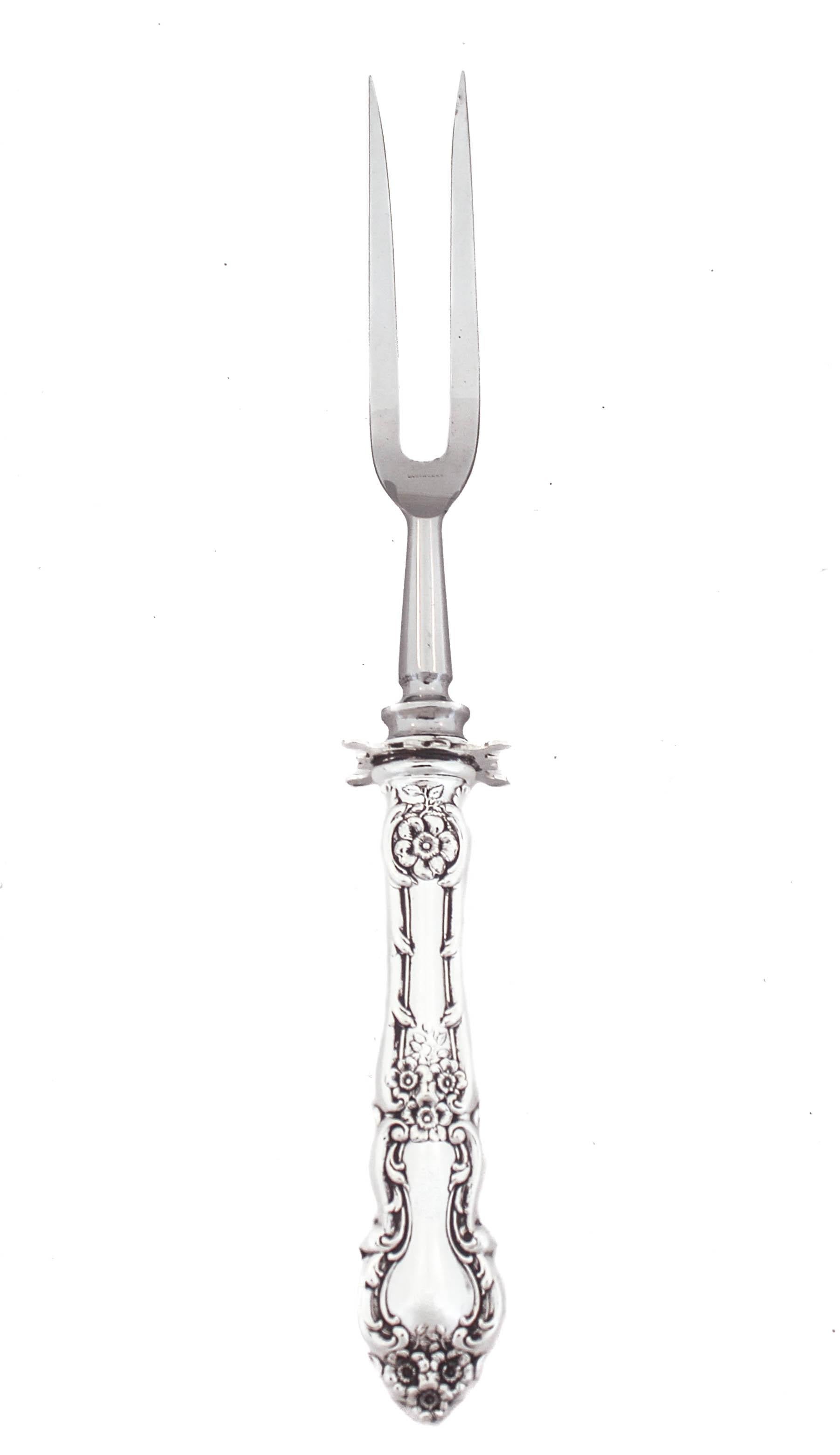 Being offered is a sterling silver carving fork and knife in the “Meadow Rose” pattern by Wallace Silversmiths, first introduced in 1907.  It has clusters of flowers on the handle and a scalloped edge.  Both pieces are large and heavy with a square