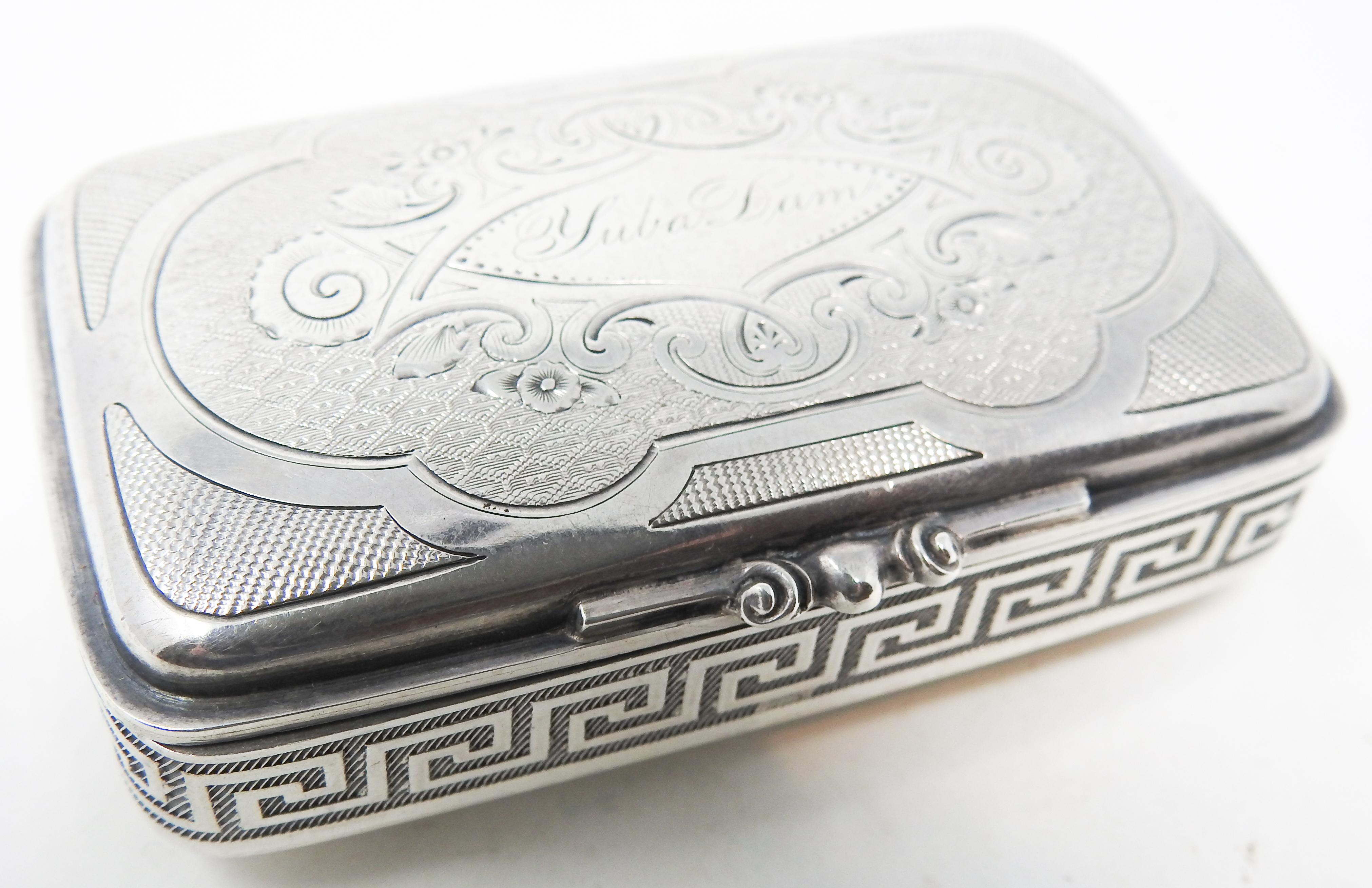 Offering this gorgeous sterling silver case with Greek key band. The top has floral, foliate, and scrollwork engraved filigree and geometric patterns. The center has an eye shape with Yuba Dam engraved. The latch is a squeeze latch and is a