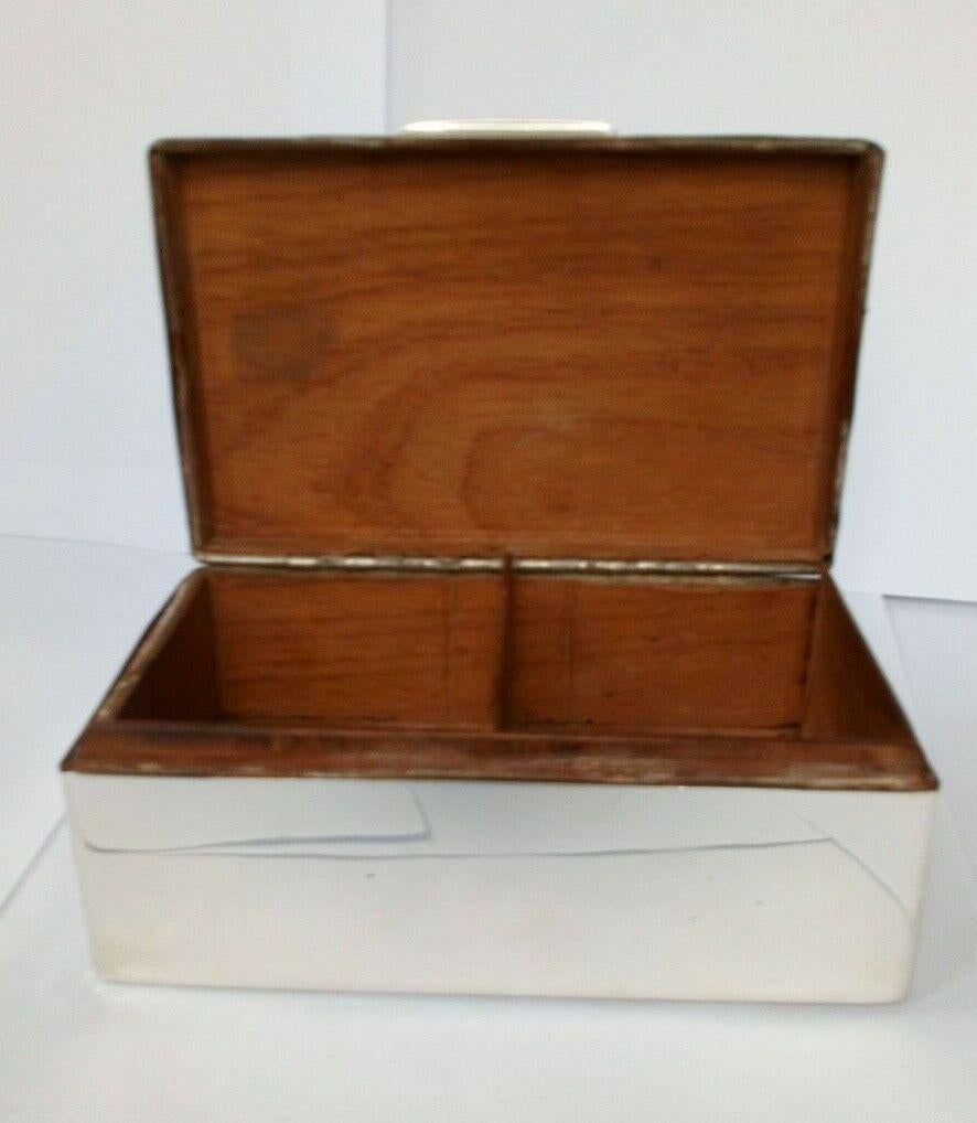 Sterling Silver Cedar-Lined Cigarette Box

In good condition, this is a beautiful piece. It is lined with cedar. It has a delicate engine-turned geometric design on the lid. Hallmarked: The box was made by WM. The maker’s and date marks are rubbed