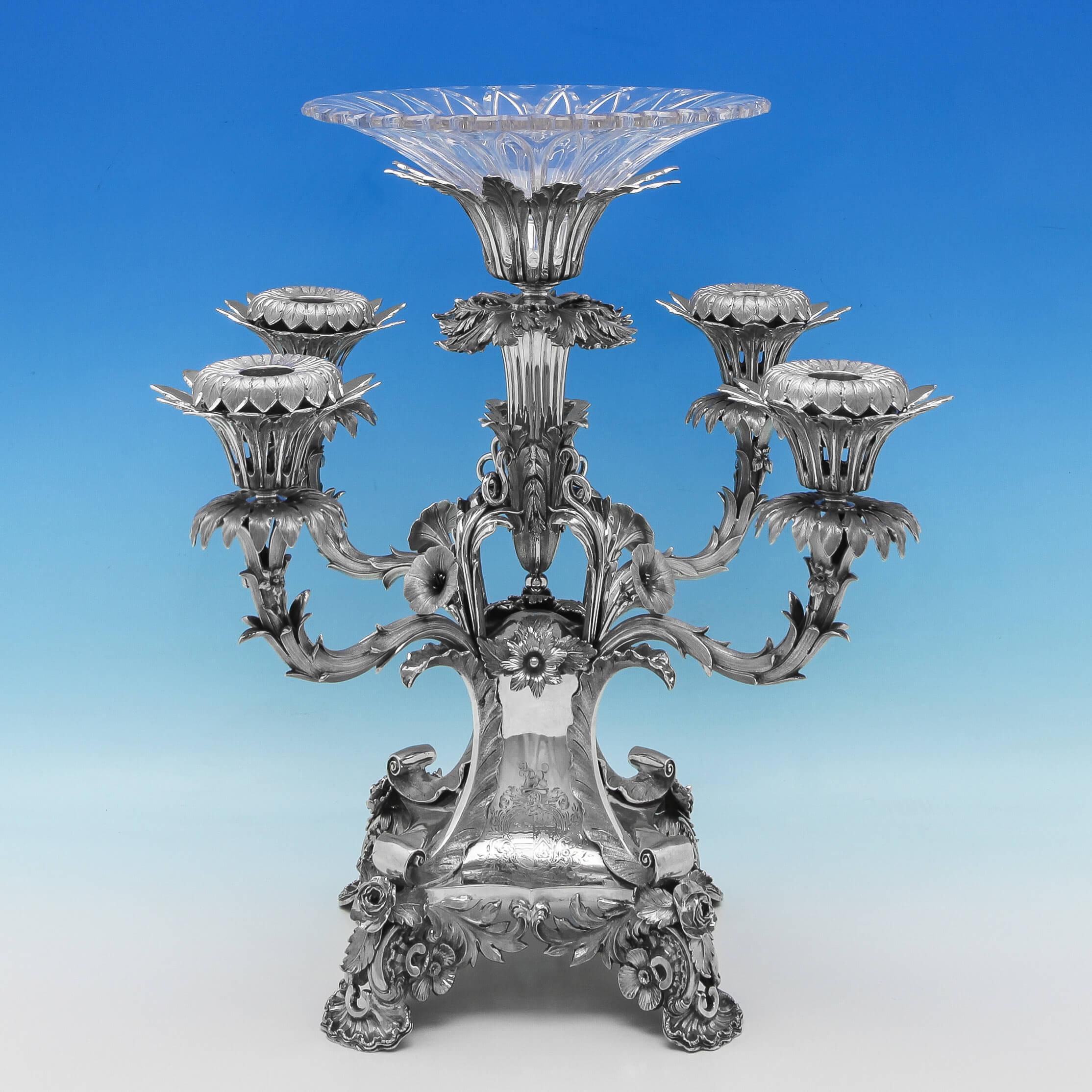 Hallmarked in Birmingham in 1834 by Robinson, Edkins & Aston, this beautiful, William IV, Antique, sterling silver centrepiece, has a central glass bowl, and 4 smaller bowls which can be switched for silver sconces to allow the use of candles.