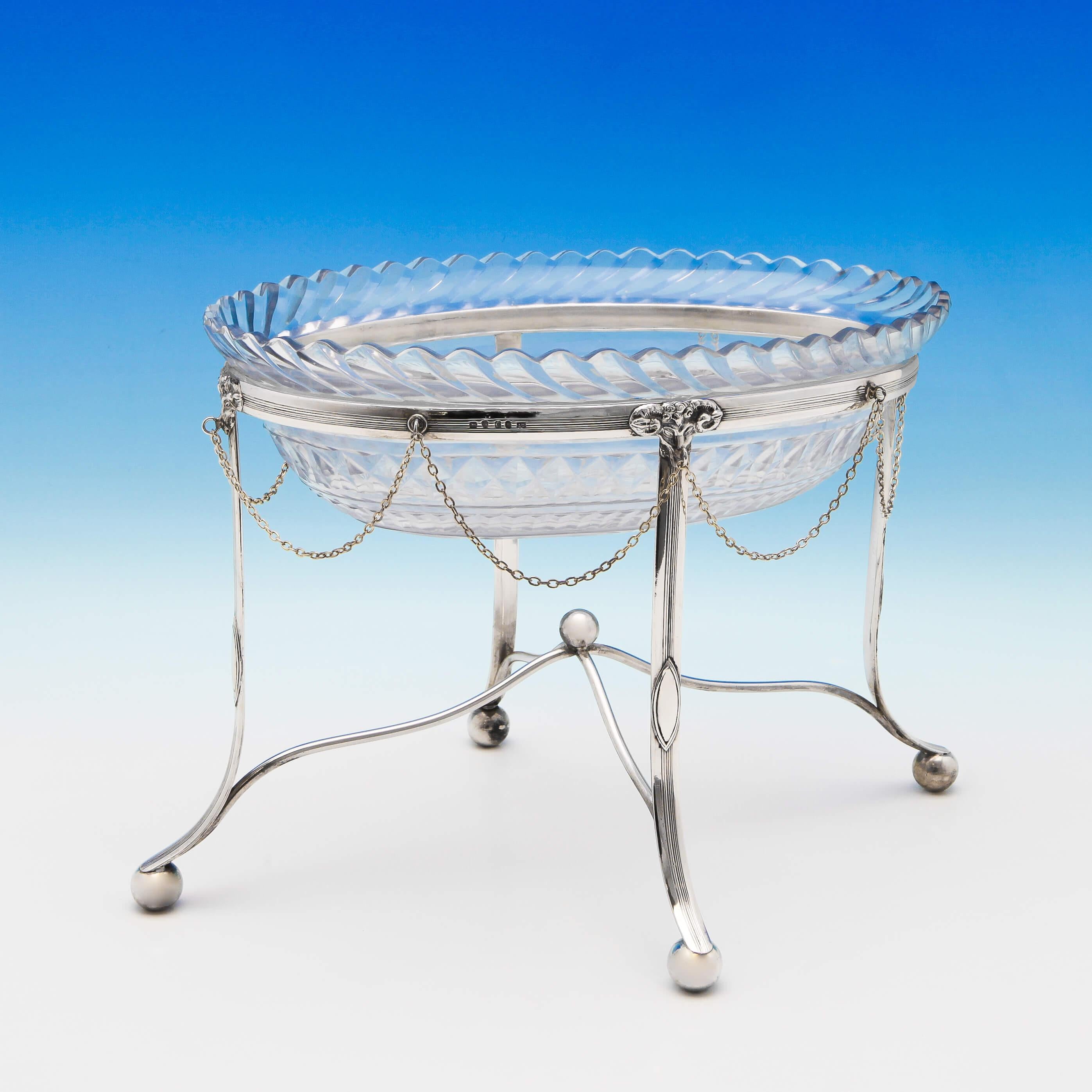 Hallmarked in London in 1798 by John Touliet, this handsome, antique, sterling silver centrepiece, features an oval glass dish supported by a neoclassical silver stand, with Adams style detailing. The centrepiece measures 9 inches (23cm) tall, by