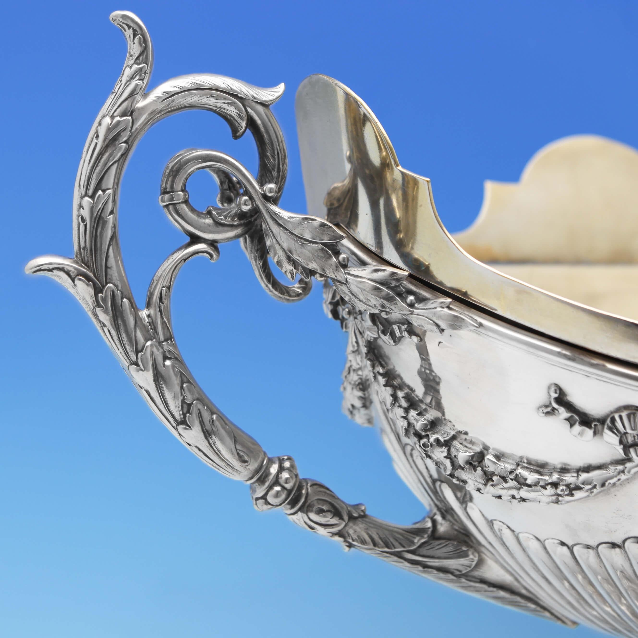 Made in Paris circa 1830 by Odiot, this spectacular 1st quality, French Antique, silver centrepiece jardinière and plateau, has an oval bowl beautifully detailed with fluting, floral garland swags and applied bows, standing on a round pedestal base