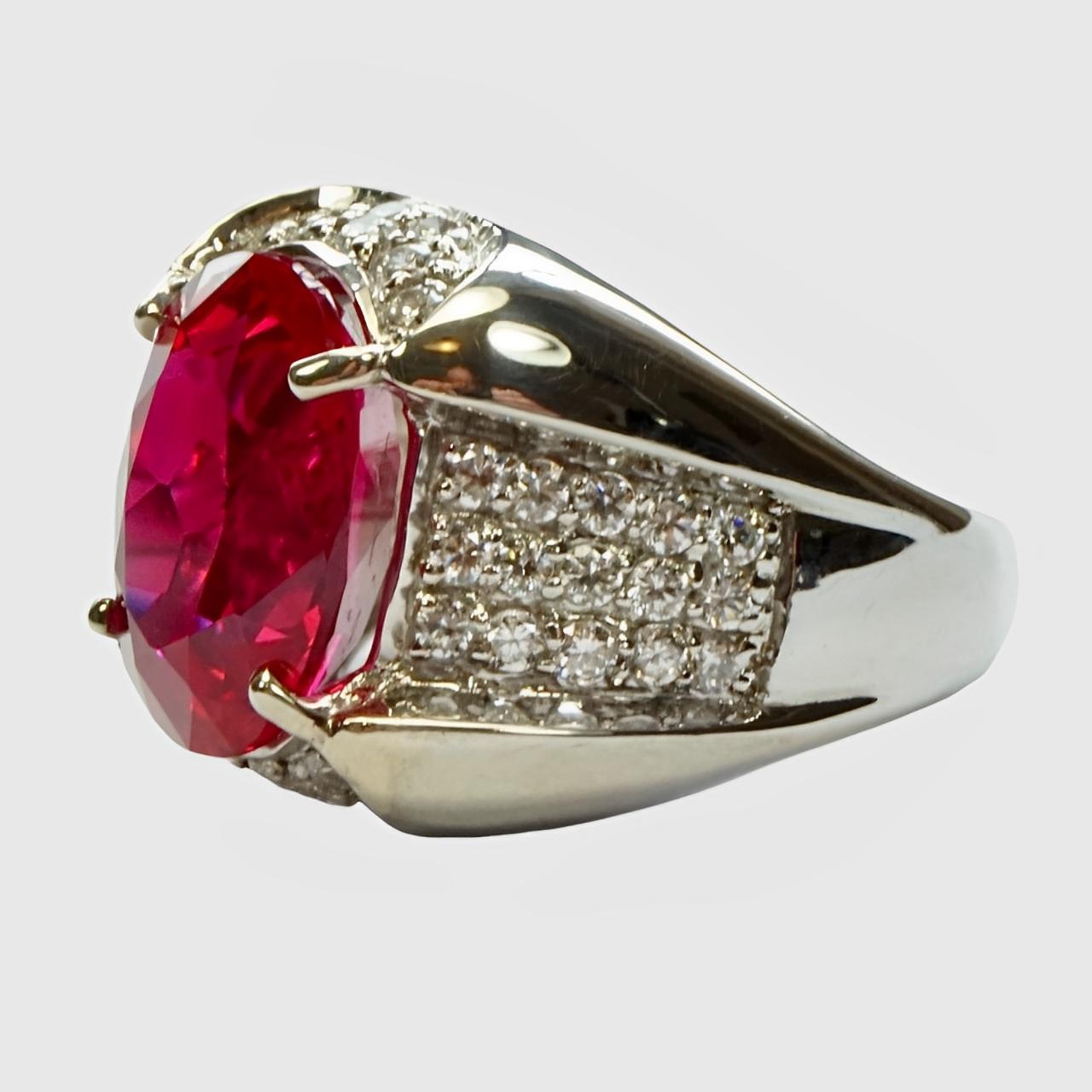 Fabulous sterling silver cocktail ring, set with a beautiful cerise pink topaz and pavé cubic zirconias. The topaz has been heat treated.

Ring size UK L 1/2,  US 5 7/8, inside diameter 1.7 cm / .67 inch. The topaz measures 1.4 cm / .5 inch by 1 cm