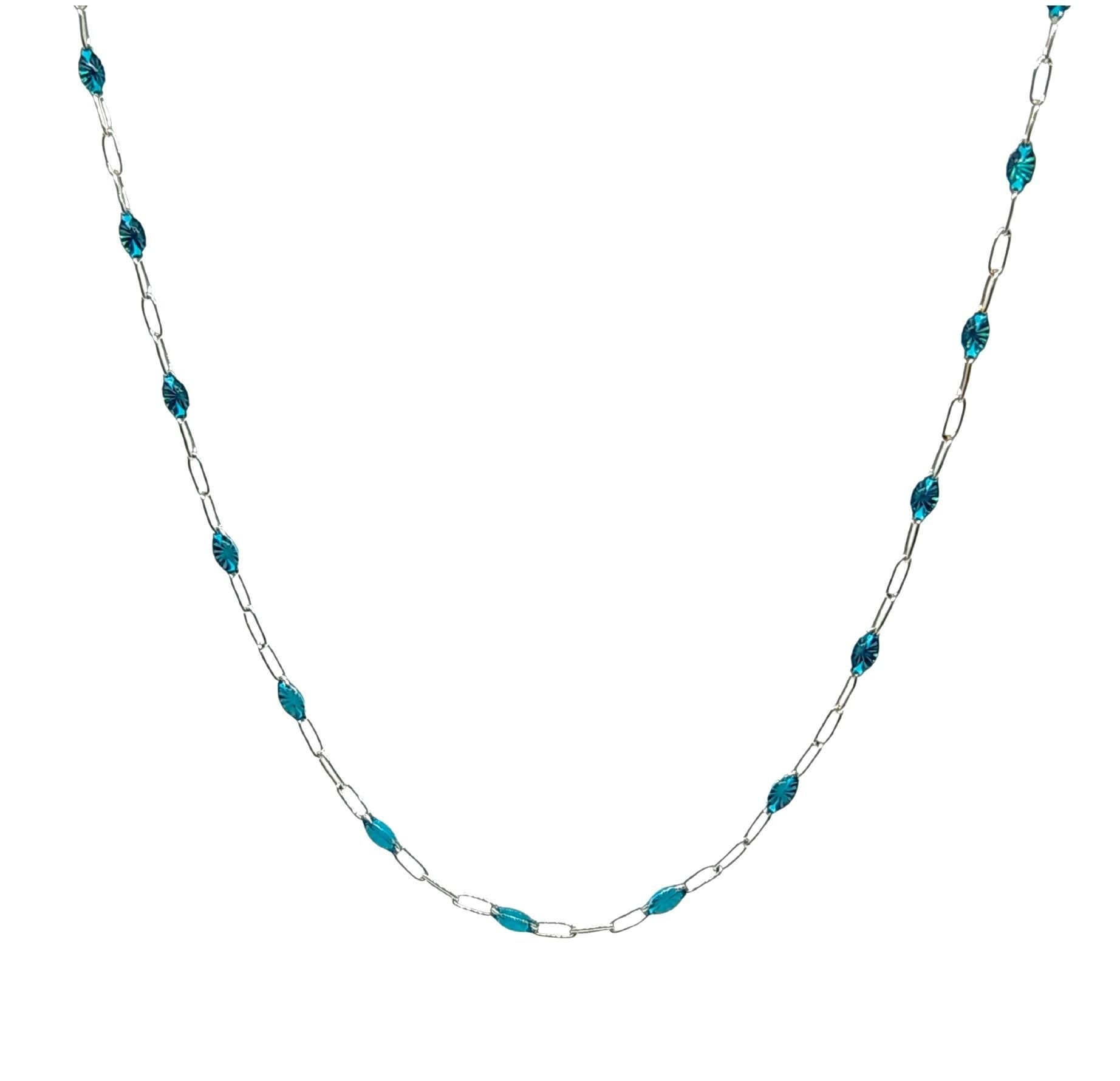A 25 Inch Sterling Silver Italian chain with translucent  teal enameled eye shape stations that elegantly are placed every half of an inch. Because the enamel is transparent, a diamond cut star is visible adding some sparkle. The silver chain is