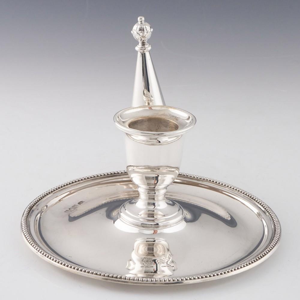 Heading : Sterling Silver Chamberstick
Date : Hallmarked in London 1903 For Hawksworth Eyre and Co
Period : Edward VII
Origin : London England
Decoration : Beaded rim and snuffer with hazelnut finial. Engraved crowned lion's head and stag
Size : 
