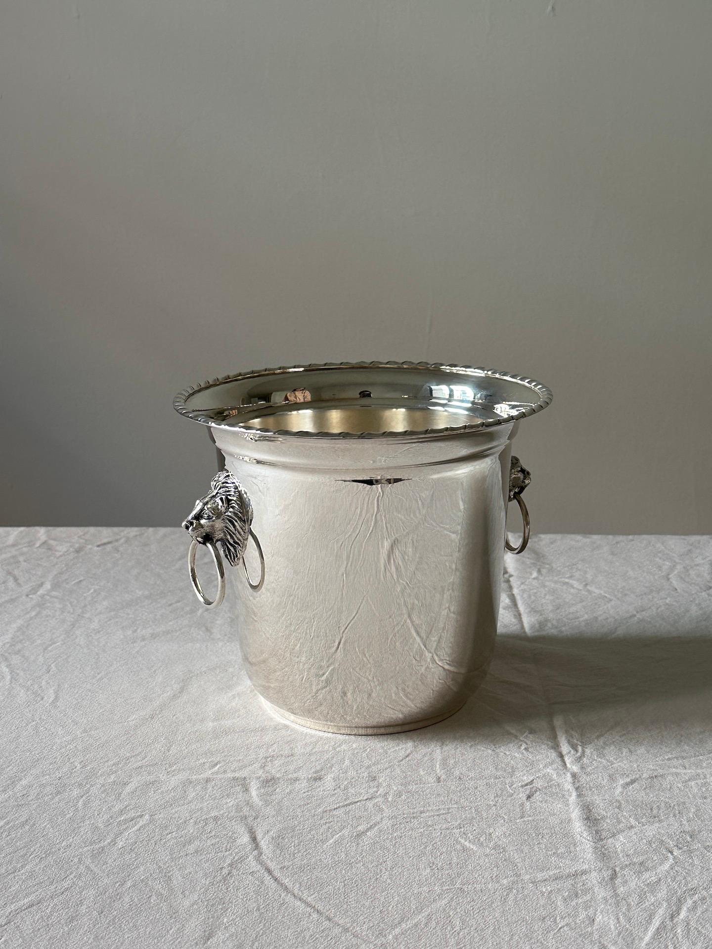 A vintage Italian Champagne bucket or wine cooler in the style of Buccellati.   The simple form has two wonderfully decorative handles. The underside is fully marked with the number of grams of silver.  Excellent condition the silver. Handles