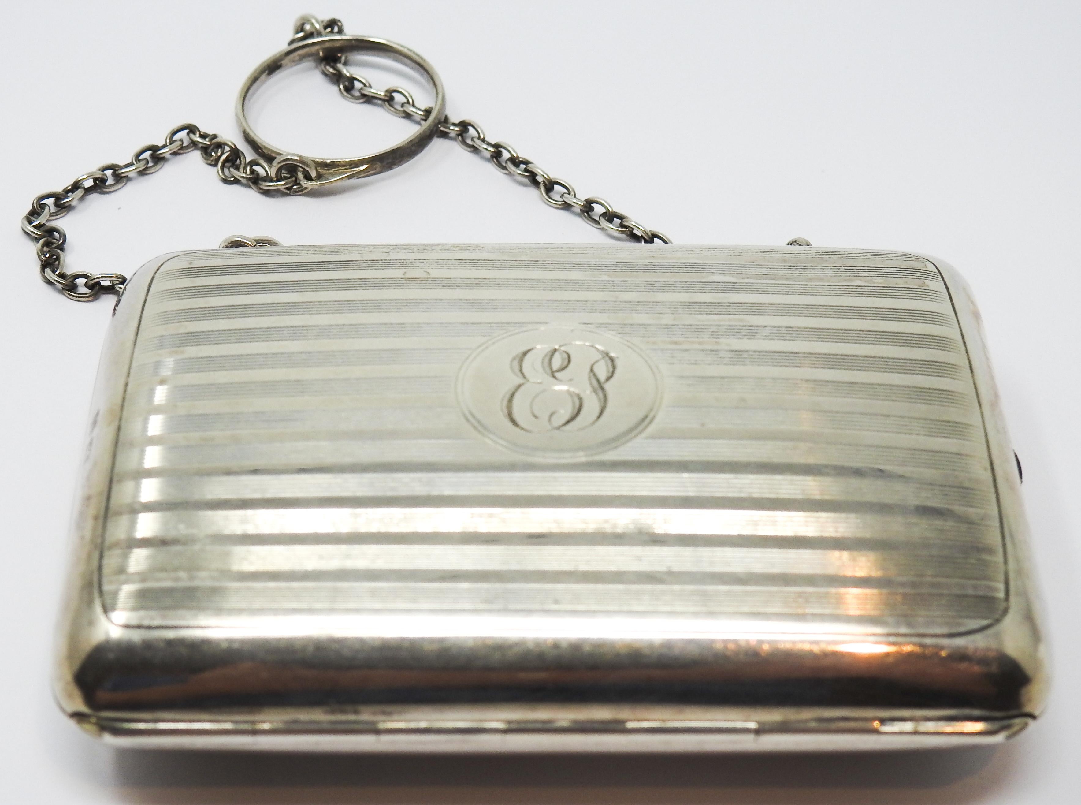 Offering this gorgeous little Art Nouveau sterling silver change purse. The front has an EP engraved in a center circle. There is a latch and button release mechanism. When opened it reveals three slots done in a dark green watermarked silk. The