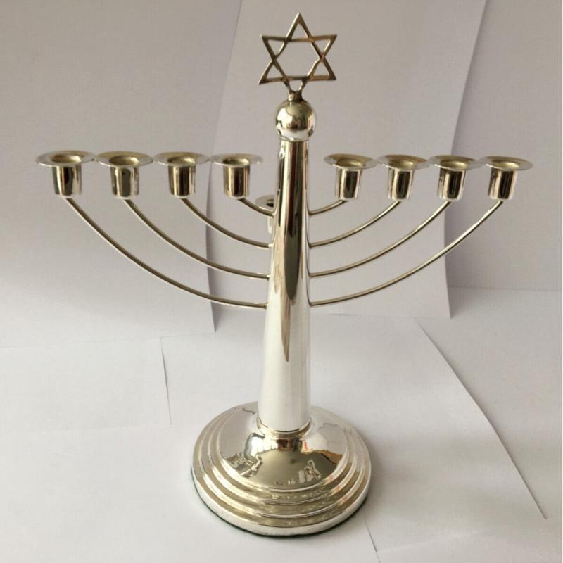 In very good condition, this beautiful, classic nine-branch menorah has a removable shamas. It is topped with a delicate Magen David and has a stylish pedestal base that is covered in green felt.
The silver is hallmarked: Made in Birmingham 1954.