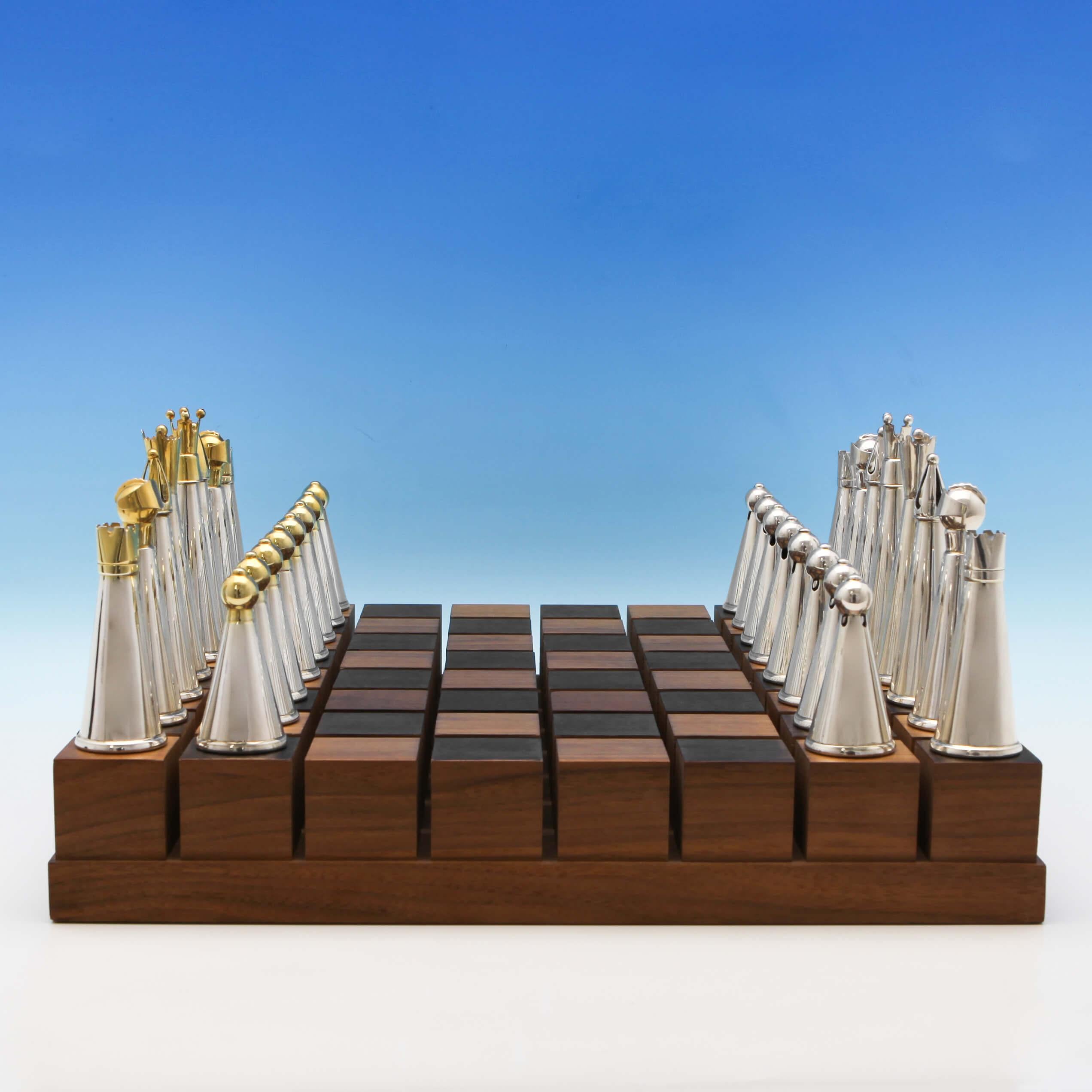 Hallmarked in London in 1988 by Michael Robert Benstead, this 'one of a kind' chess set is beautifully made from sterling silver and silver gilt on an American walnut base. The base measures 16 inches (40.5cm) square, the king measures 5 inches