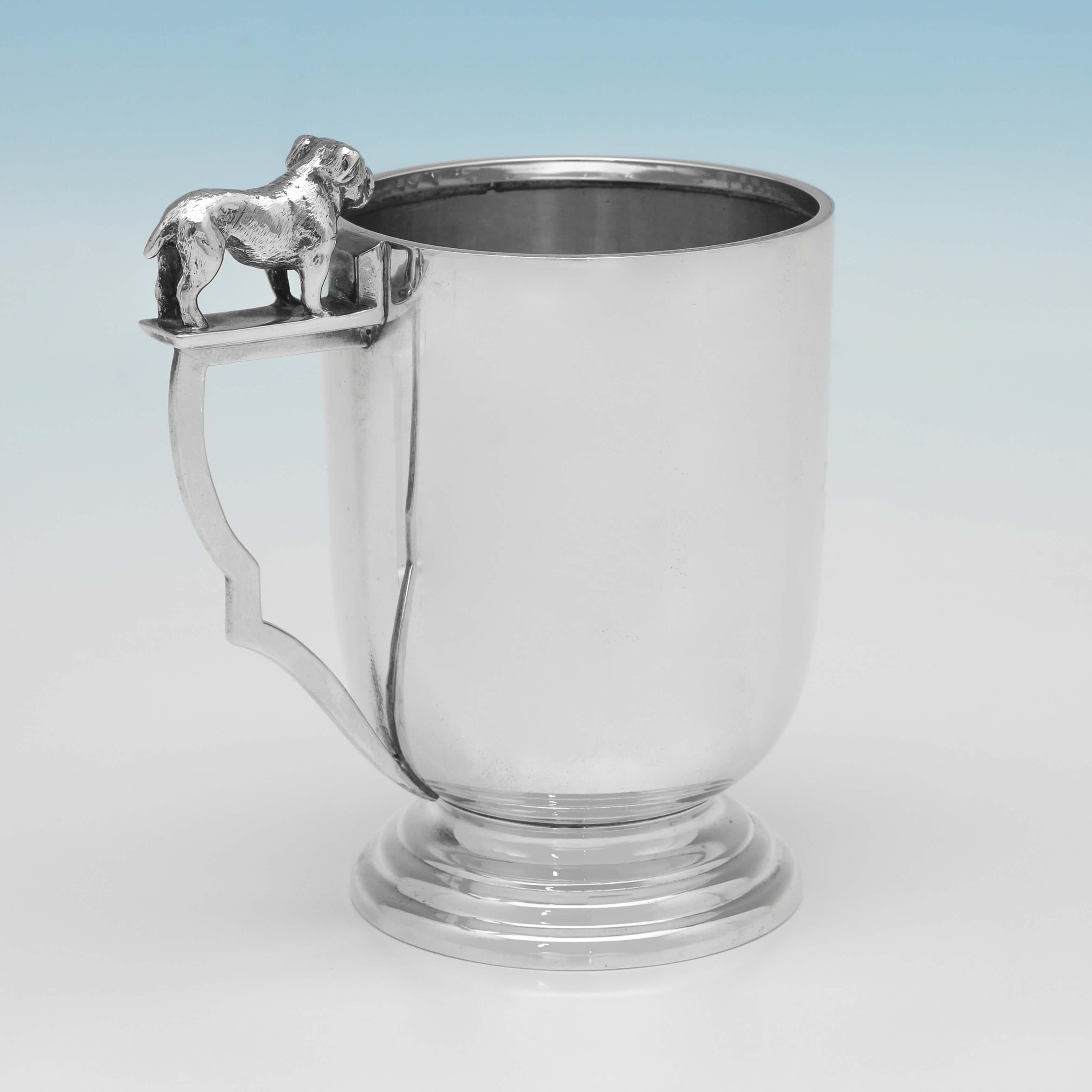 Hallmarked in Birmingham in 1937 by Sanders & Mackenzie, this handsome, Sterling Silver Christening Mug, is plain in design, and features a cast model of a bull dog on the handle. The Christening mug measures 4.25