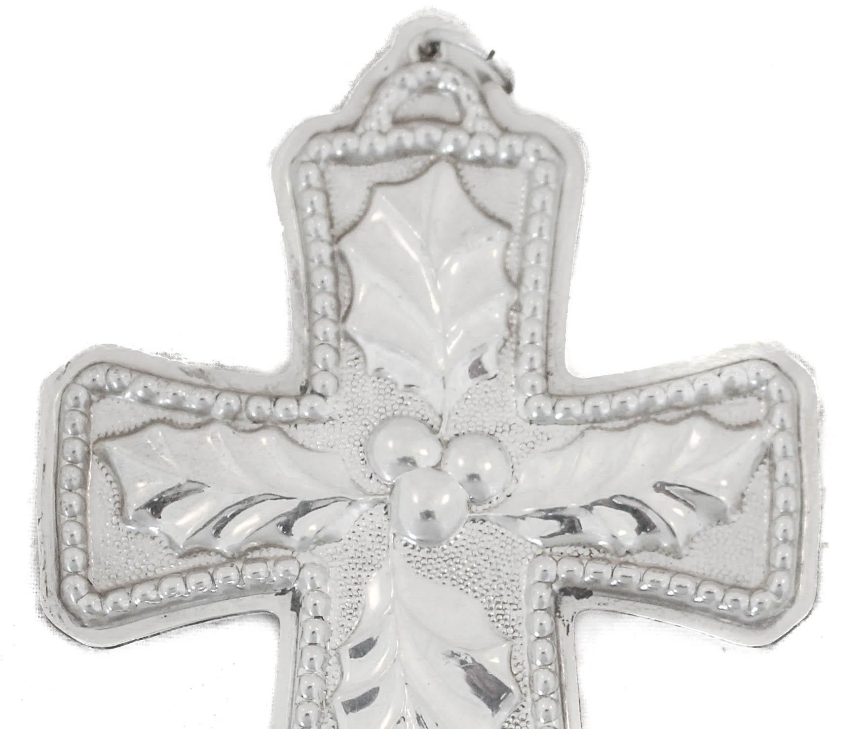 We are happy to offer you this sterling silver Christmas ornament by Tuttle Silversmiths. It’s a cross with Christmas holly and in the center a clump of berries. Such a wonderful and appropriate ornament to decorate your tree and grace your home.