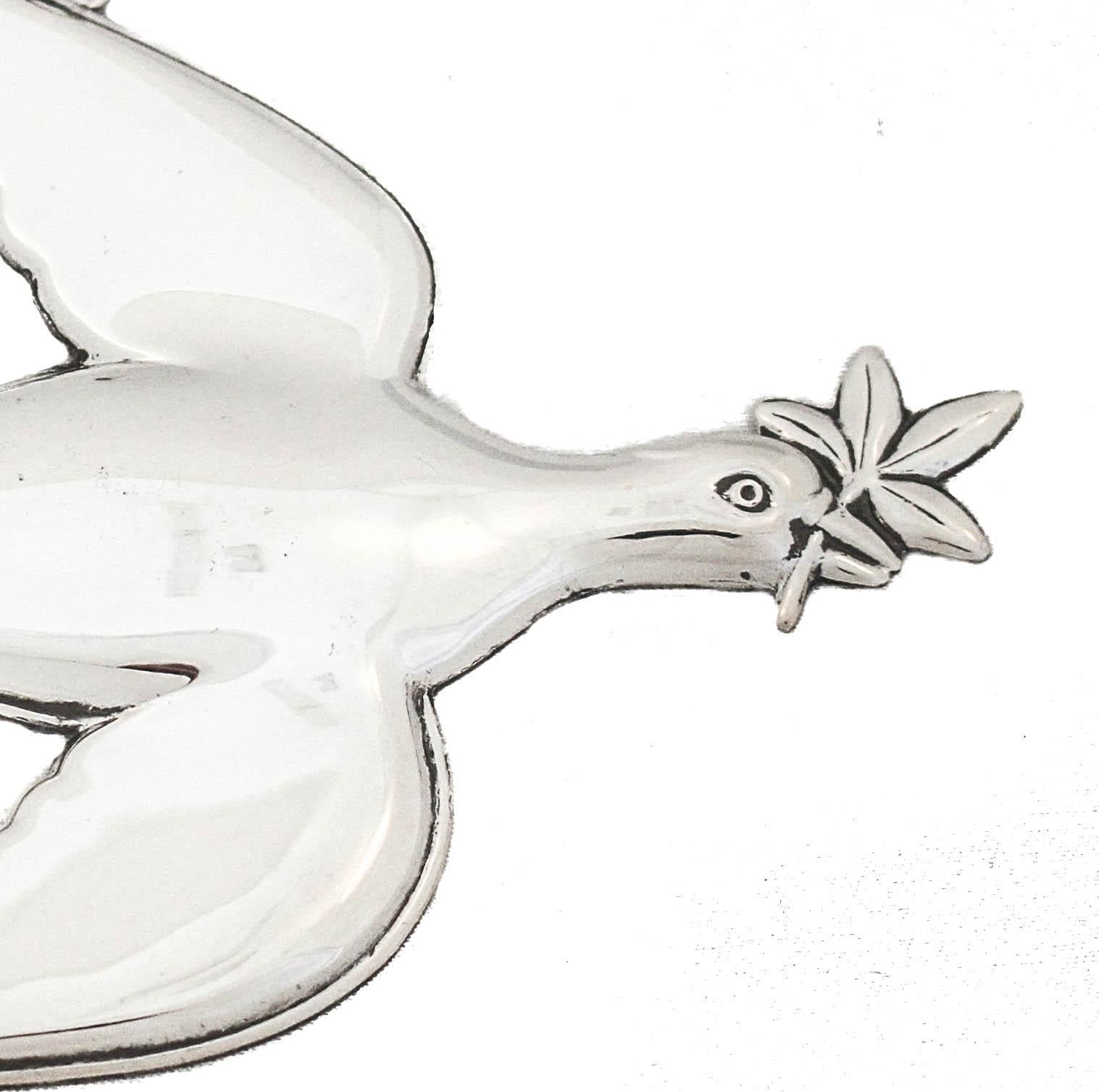 Being offered is a sterling silver Christmas ornament made by Gorham Silversmiths of Providence, Rhode Island, circa 1972.  It is of a Mount Vernon Dove with an olive branch in its beak.  An olive branch represents peace, good-will and friendship