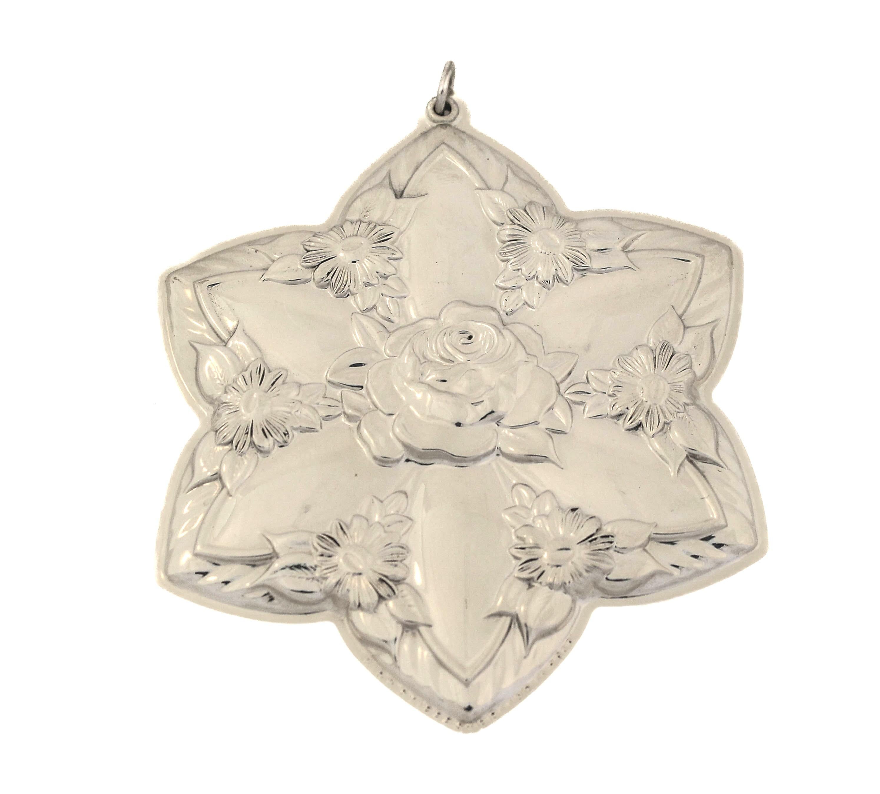 Being offered is a sterling silver Christmas ornament by Kirk Stieff Silver of Maryland.  It is a six pointed shaped flower with flowers in between each indentation and a larger flower in the center.  The design is found on both sides so there’s no