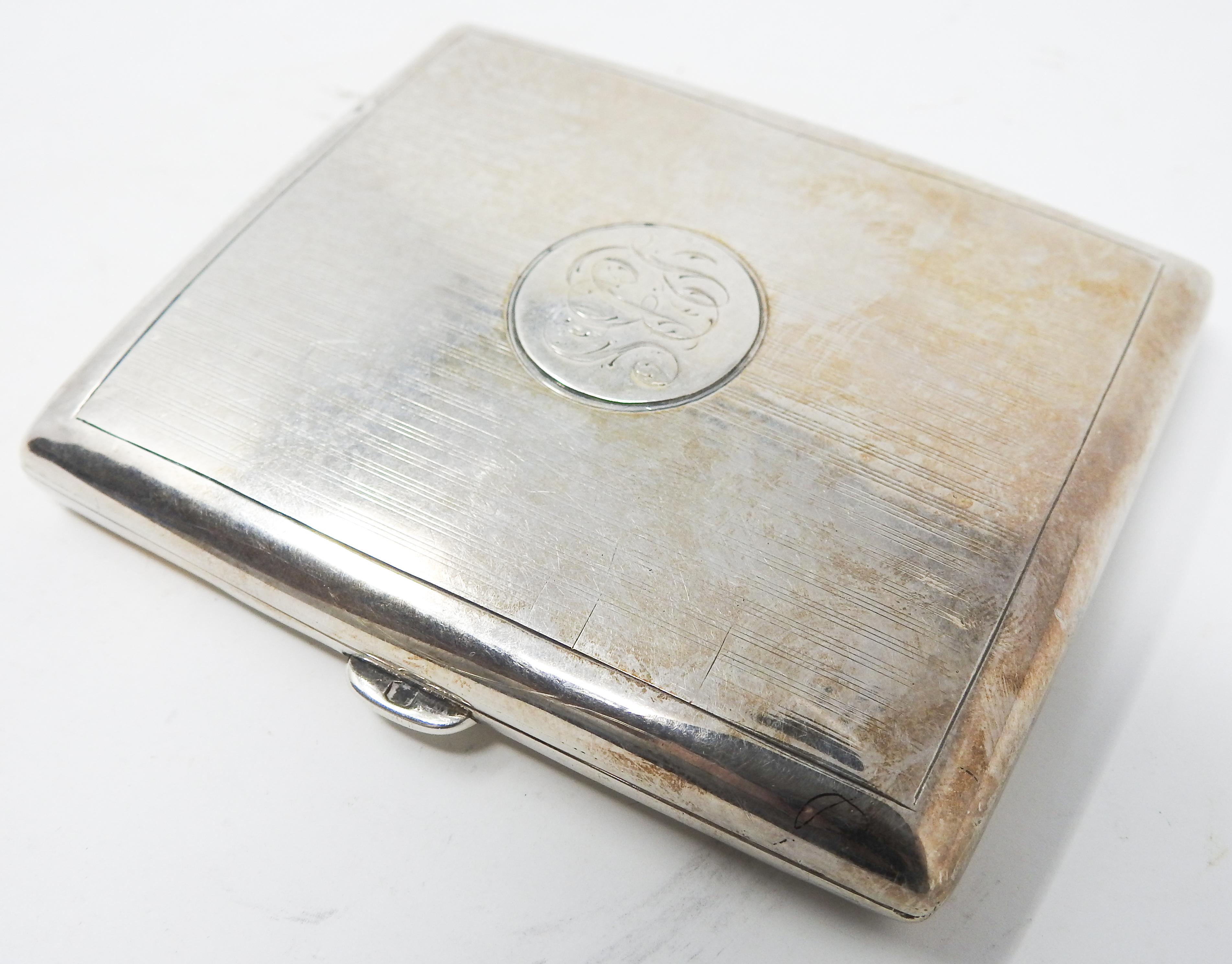 Offering this gorgeous sterling silver cigarette case. The outside of the case is simple with lines and geometric patterns and the initials LBS. The latch is a push button mechanism. When opened the inside is a matte finish. The inside is also