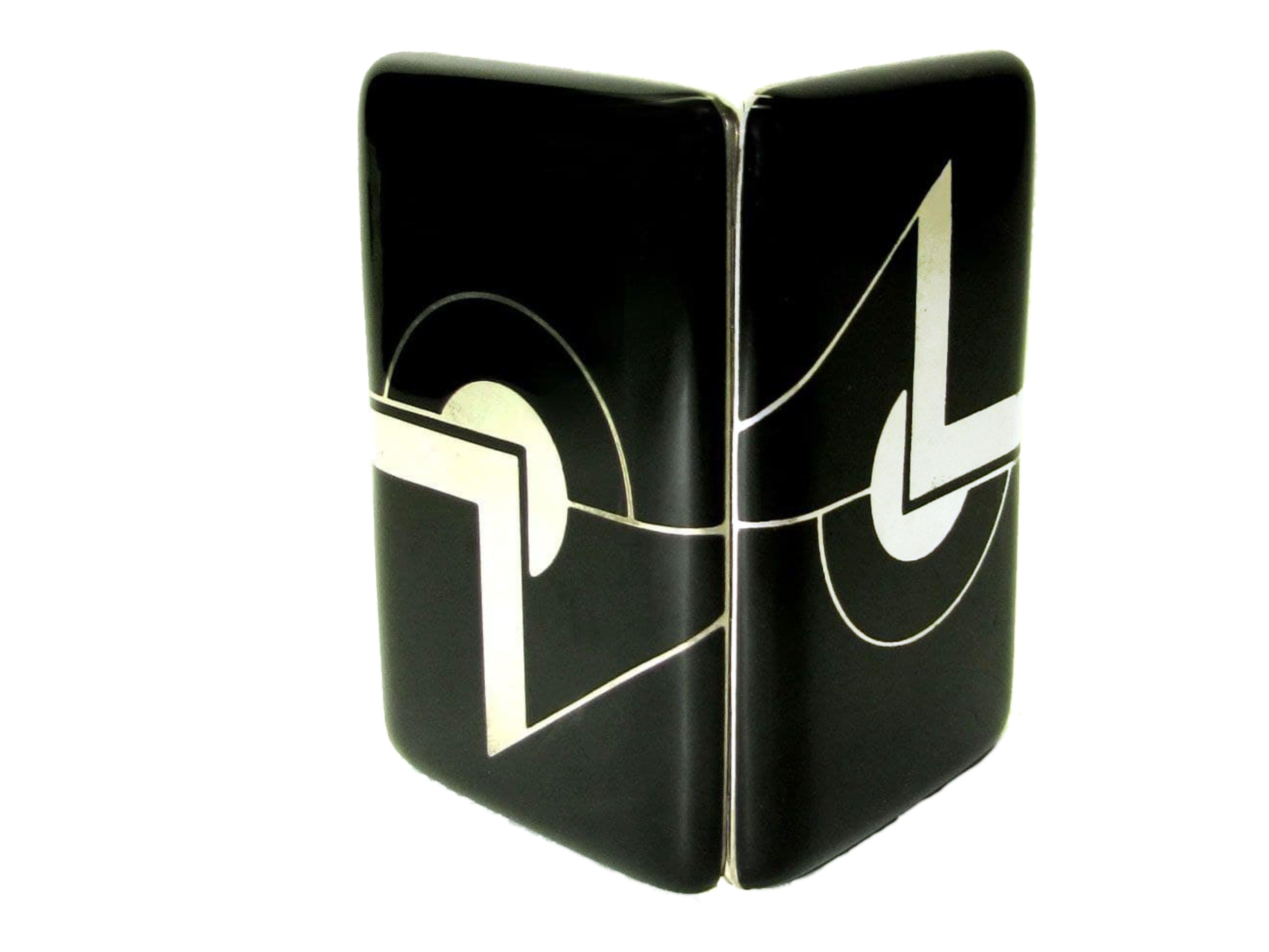 Cigarette case for handbag in 925/1000 sterling silver with black fired enamel. Opening with spring button. Size cm. 6.3 x 9.7 x 1.5 . Created in Art Deco style for Cartier USA in the 1980s, inspired by designs by Louis Cartier from the early