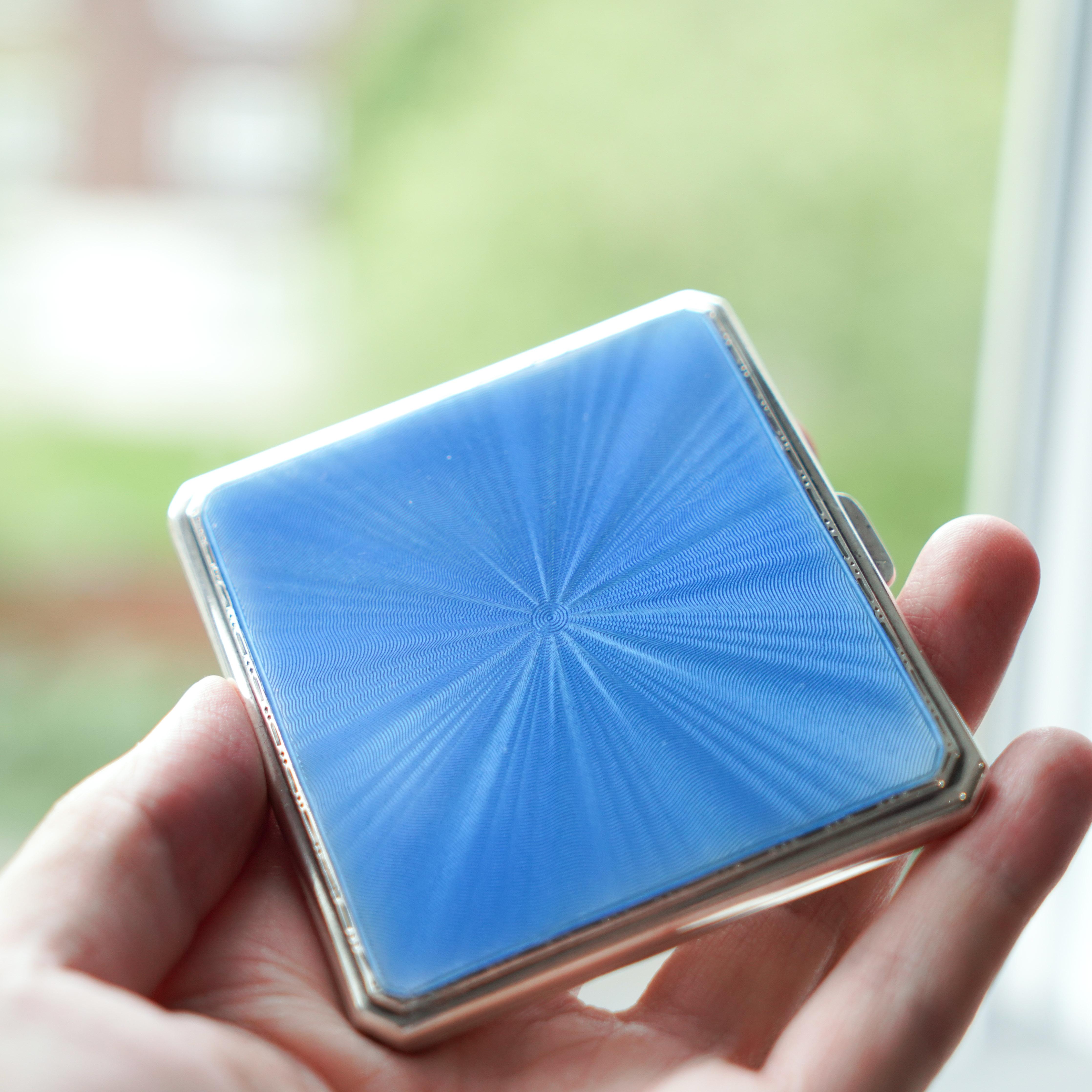 We are delighted to offer this stunning sunburst light blue enamel and sterling silver cigarette case, made by A E Poston & Co Ltd in Birmingham 1937.
  
With practicality, elegance and style combined in one, this cigarette case is the perfect