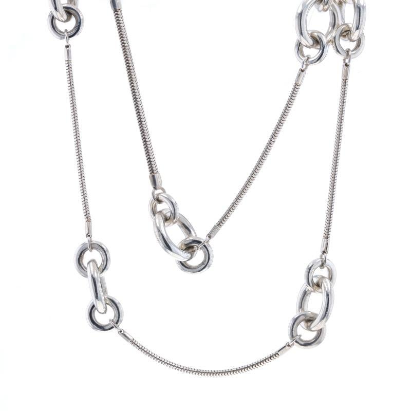 Metal Content: Sterling Silver

Chain Style: Flat Snake
Necklace Style: Chain Circle Link Station
Fastening Type: Lobster Claw Clasp

Measurements

Chain Width: 1/8