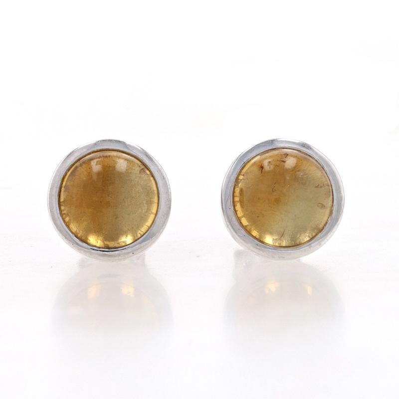 Metal Content: Sterling Silver

Stone Information
Natural Citrines
Treatment: Heating
Cut: Round Cabochon
Color: Yellow
Diameter: 8mm

Style: Stud
Fastening Type: Butterfly Closures

Measurements
Diameter: 13/32