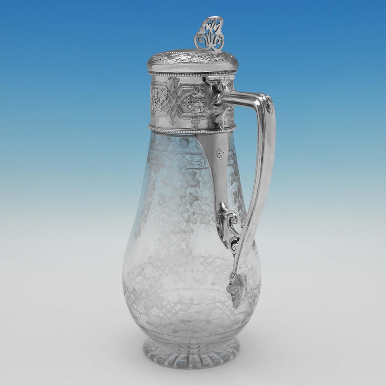 Hallmarked in Sheffield in 1875 by William & George Sissons, this stunning, Victorian Antique Sterling Silver Claret Jug, is beautiful in design, with etching to the glass which mirrors the engraving to the silver mount. The claret jug measures