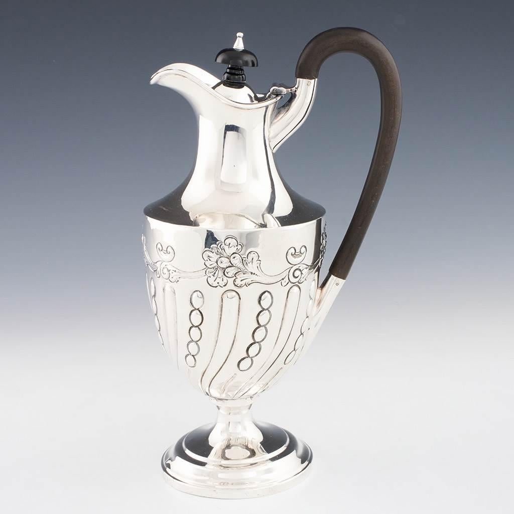 Heading : A Sterling Silver Claret Jug
Date : Hallmarked in Sheffield 1897 For James Deakin & Sons
Period : Victoria
Origin : Sheffield. Yorkshire. England
Decoration : Repousse scrolls and leaves. terraced pedestal foot. Ebony and silver