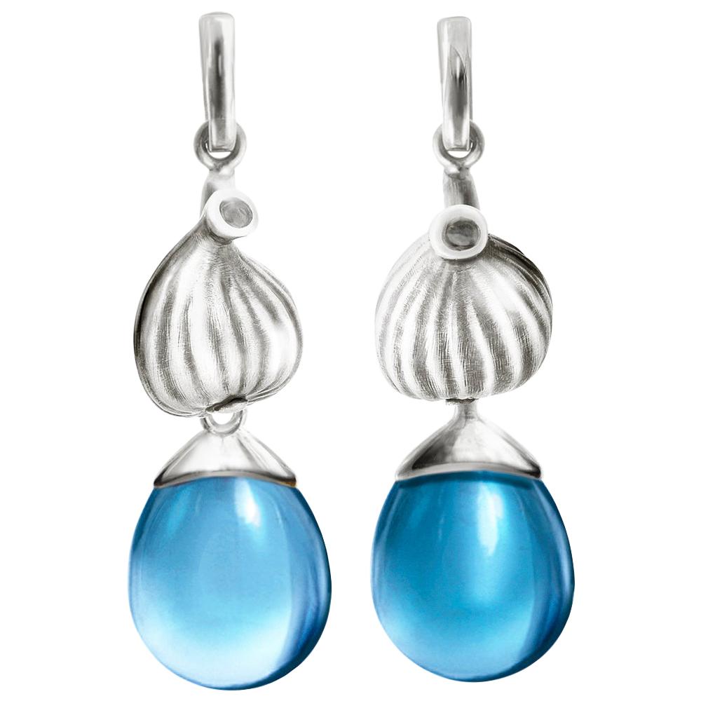 These Fig Fruits clip-on cocktail earrings are in sterling silver with cabochon cut blue topazes drops. The earrings were featured in Vogue UA review, and designed by the artist and oil painter from Berlin.

These earrings fit best for blonde and