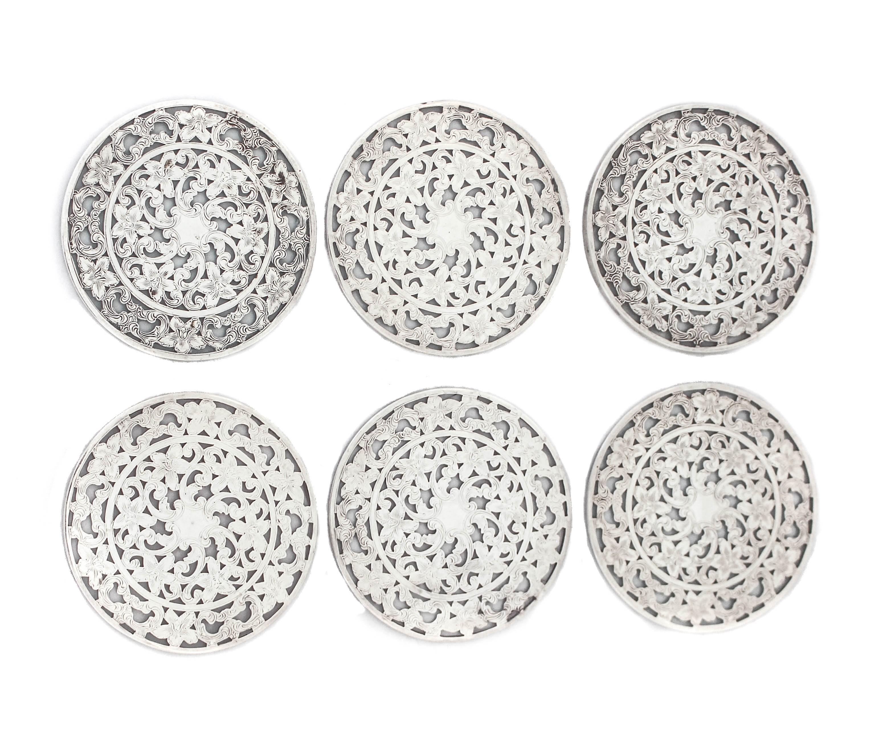 These sterling silver coasters are just what you need when entertaining. They have a beautiful open work design and a glass bottom. Made by the Webster Silver Company, they will protect your table from cups and glass stains. Stackable and easy to
