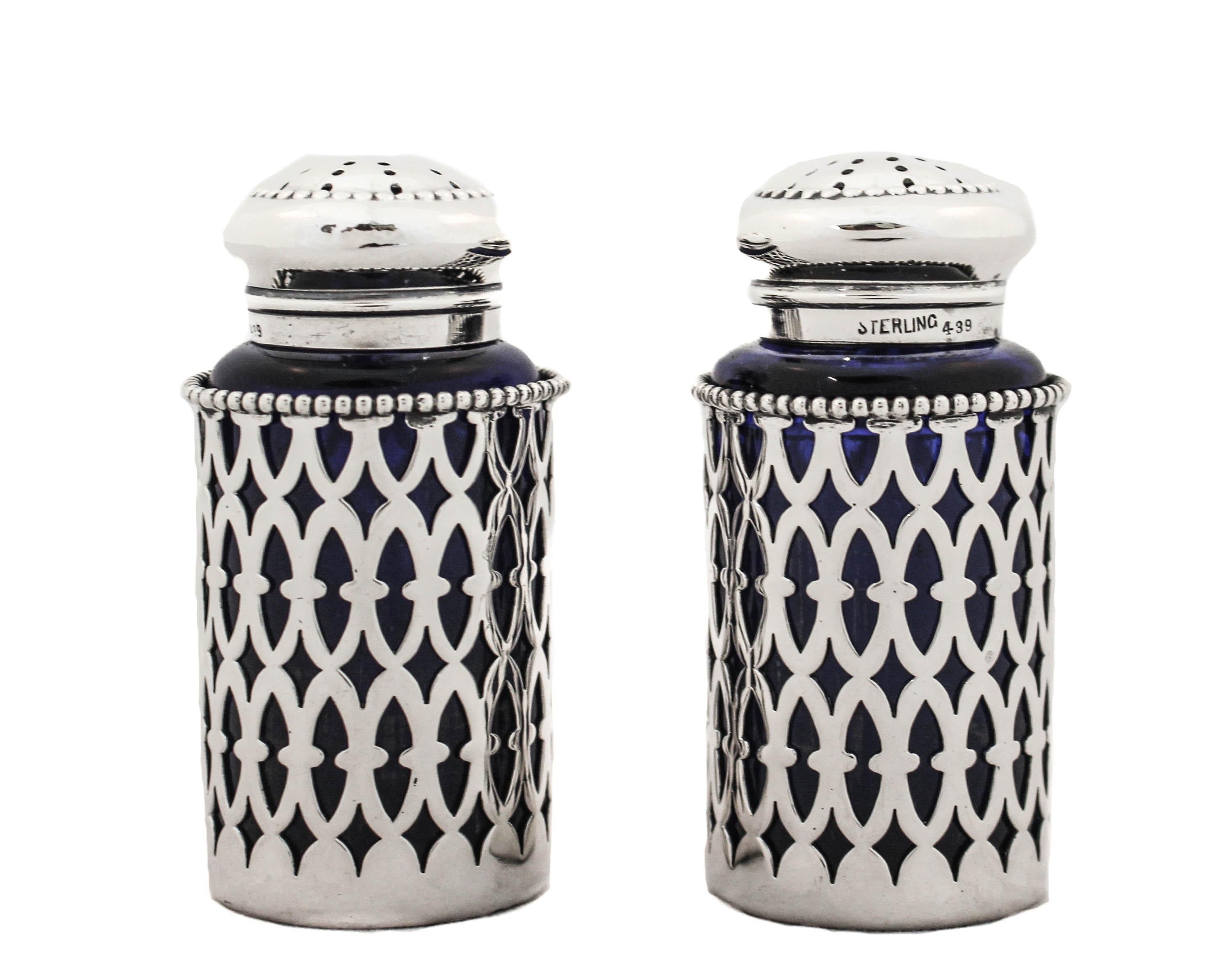 Proudly offering this pair of Art Deco sterling silver salt shakers with cobalt glass liners. They have a geometric cutout pattern overlay on cobalt glass. The top come off and are easy to fill.  Never need to worry about the salt eroding the