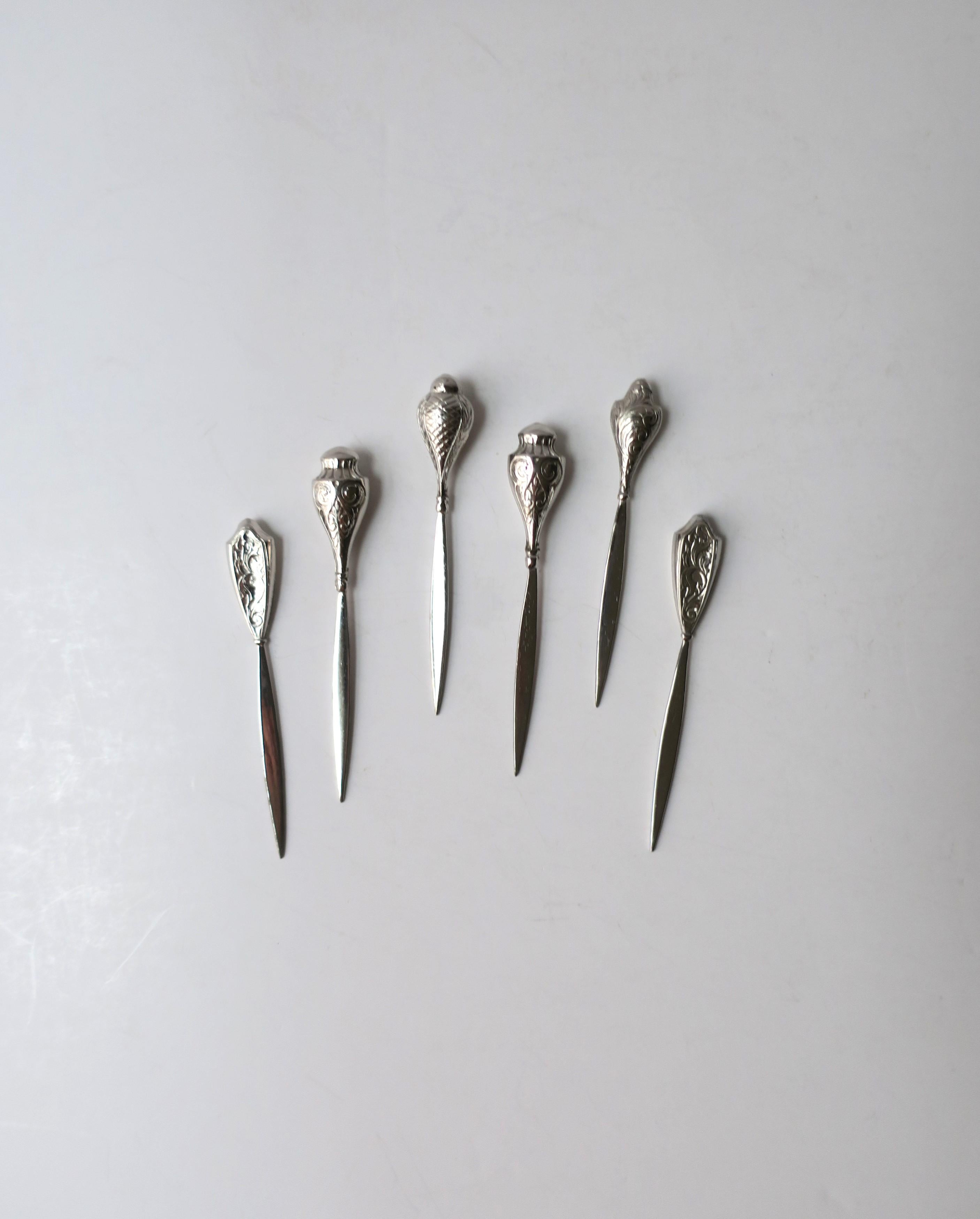 A beautiful set of six (6) sterling silver cocktail or appetizer picks, circa early to mid-20th century, USA. A great set for a bar, bar cart, entertaining, etc. Each are stamped 'Sterling' on blade, please see last image. Excellent condition as