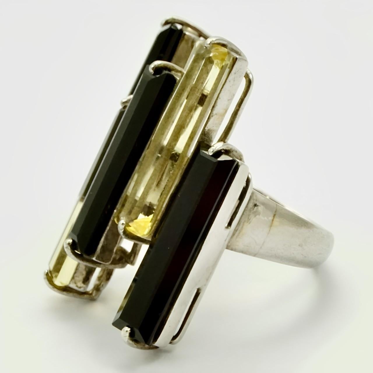 Wonderful sterling silver ring set with black and citrine faceted glass. Ring size UK N 1/2, US 6 3/4, and measuring inside diameter approximately 1.8 cm / .7 inch. The glass stones are 2 cm / .78 inch each in length. The silver has scratching as