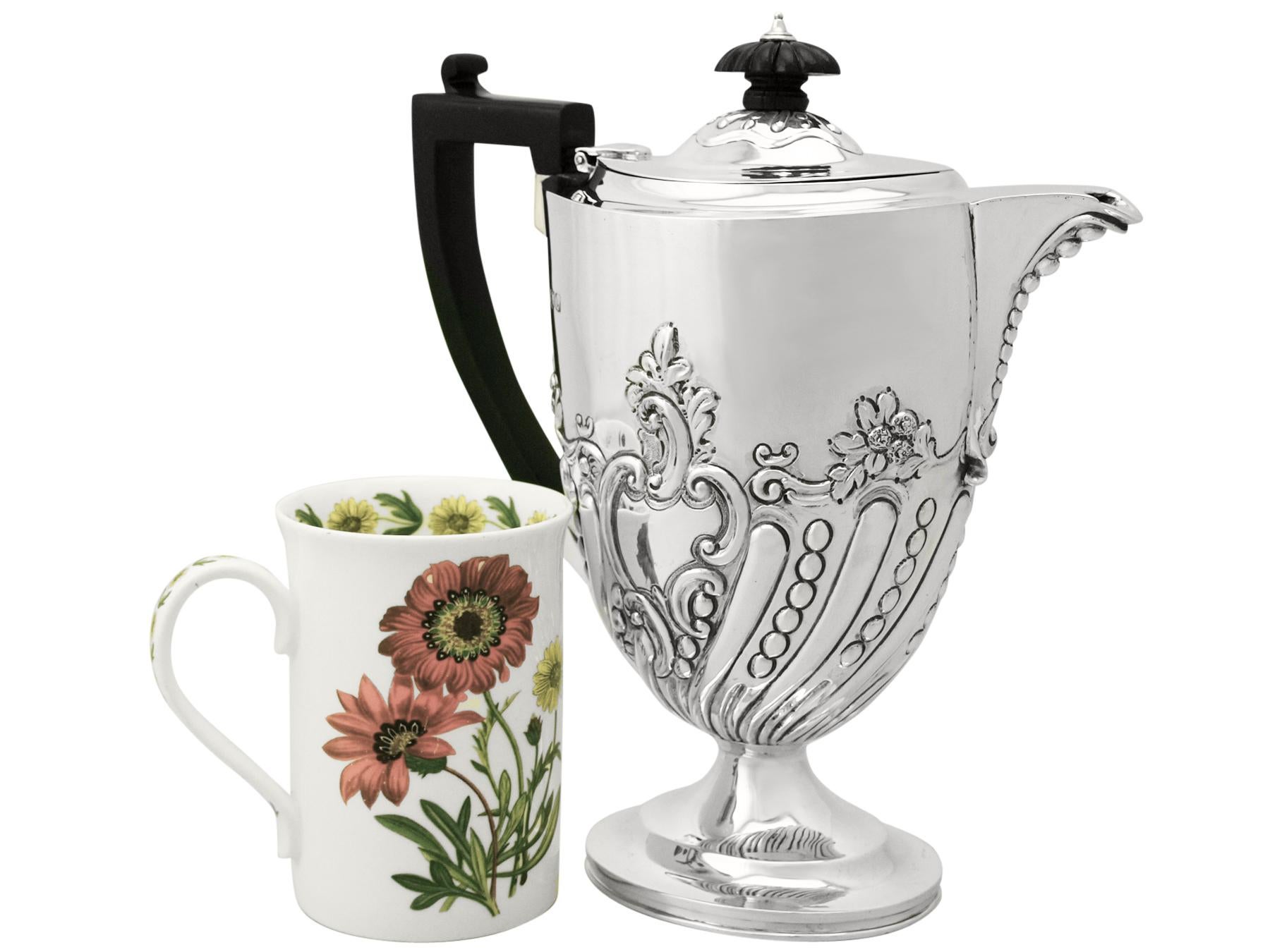 A fine and impressive antique Victorian English sterling silver coffee jug made by Charles Stuart Harris; an addition to our range of silver teaware.

This fine antique Victorian sterling silver coffee jug has an oval rounded Queen Anne form onto