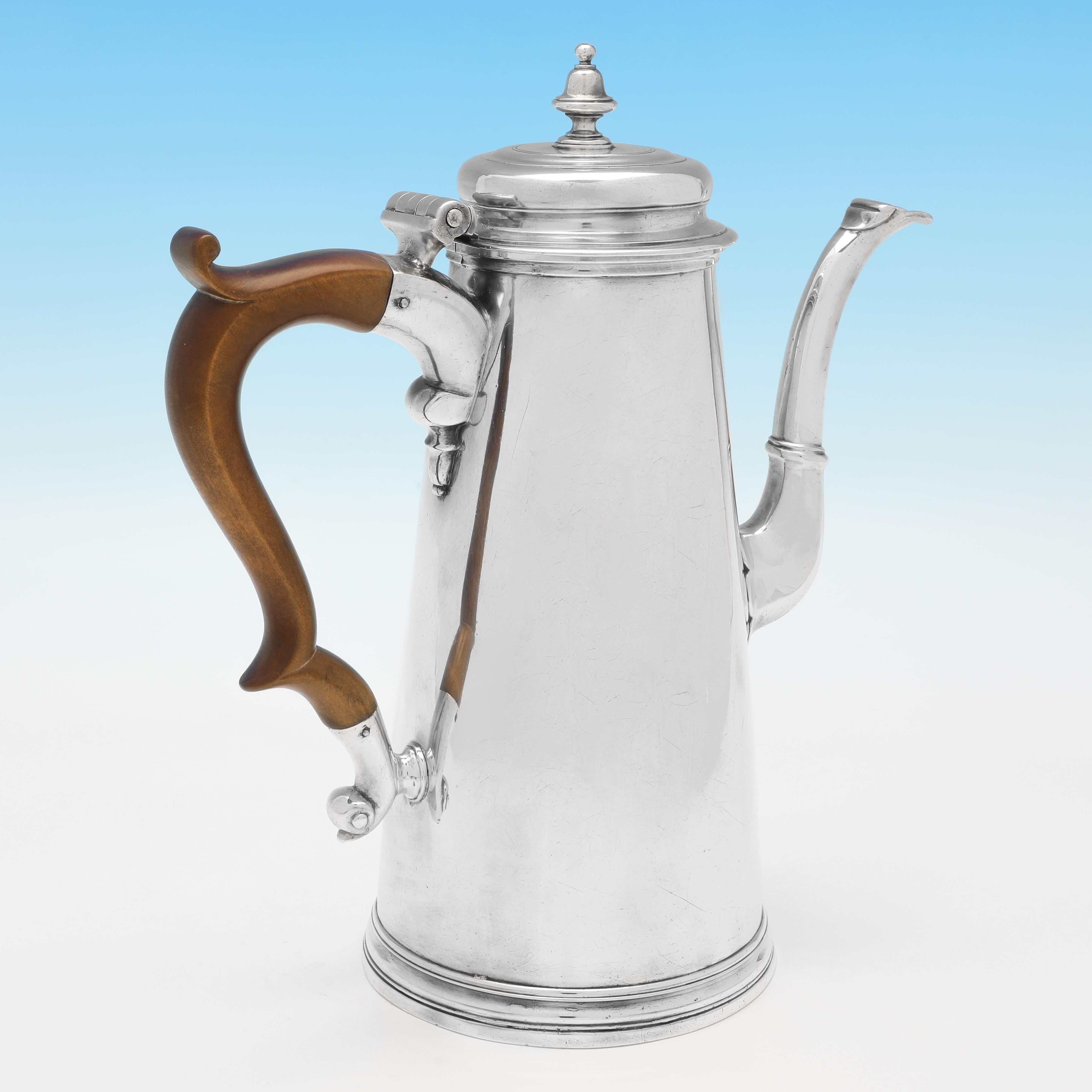 Hallmarked in London in 1733 by Thomas Farren, this handsome, George II Antique Sterling Silver Coffee Pot is straight sided with reed borders. The coffee pot measures 9.25
