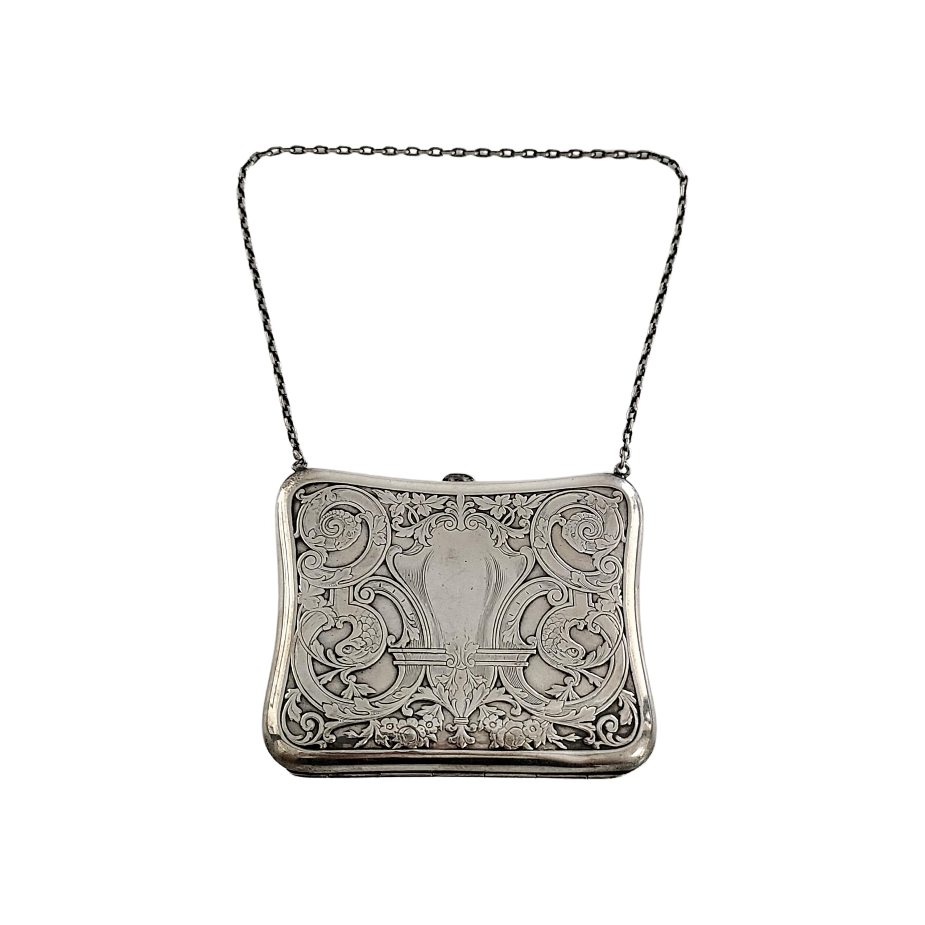 Sterling silver coin purse.

Floral and fish flourish design with monogram on one side. Oval link chain strap, push button open and closure.

Monogram appears to be AEP

Measures approx 3 3/4